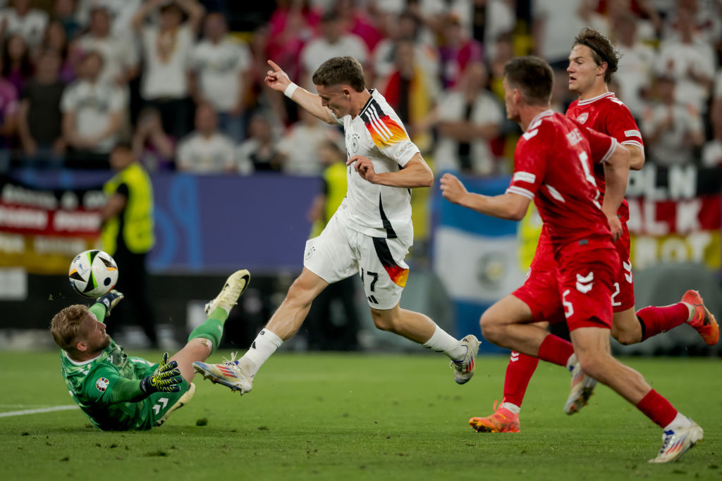 (L-R) Kasper Schmeichel of Denmark, Florian Wirtz of Germany, Joachim Andersen of Denmark compete for the ball. Euros 2024