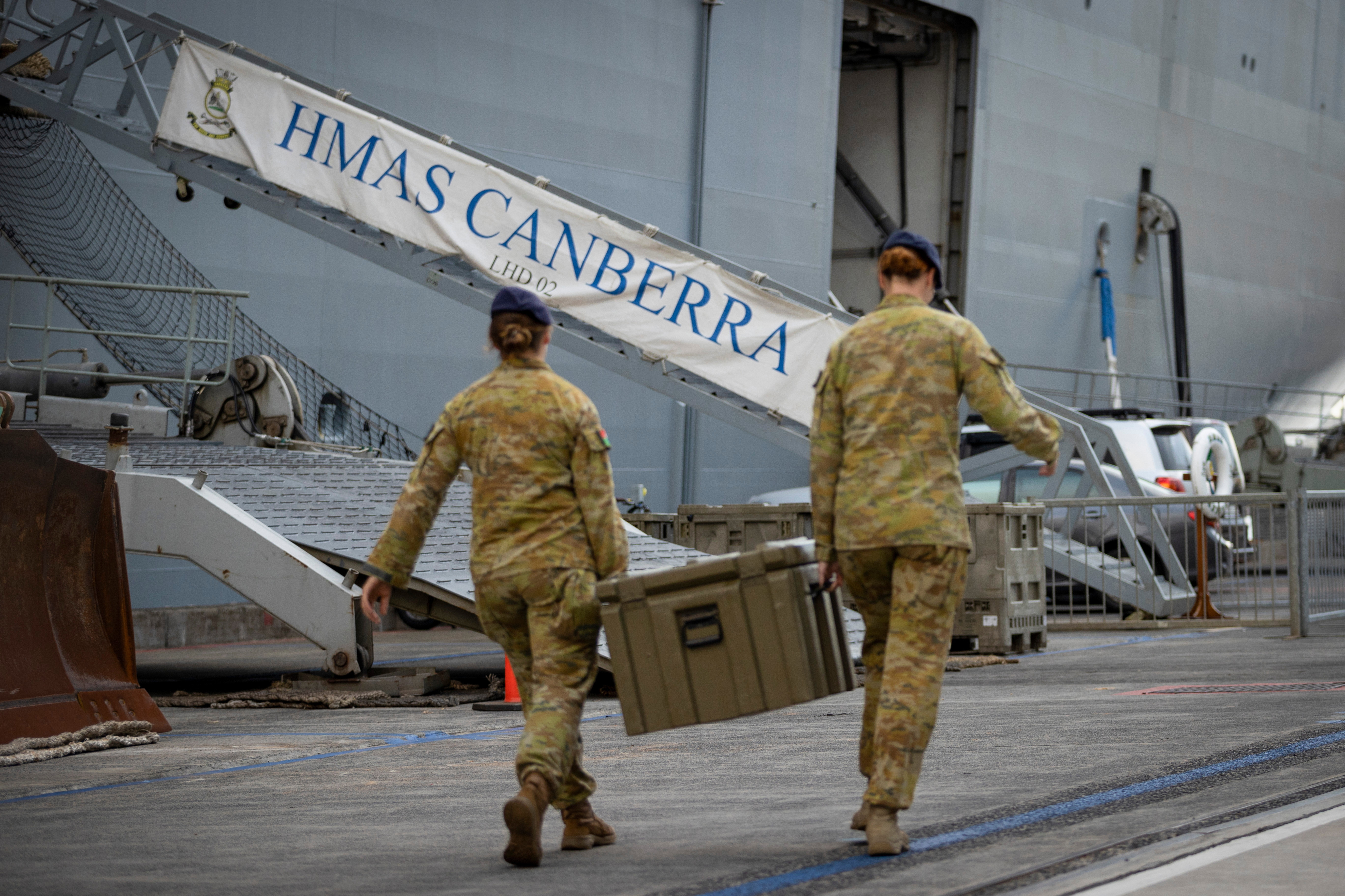 Australian Army personnel load stores onboard HMAS Canberra alongside Garden Island Defence Precinct, NSW.