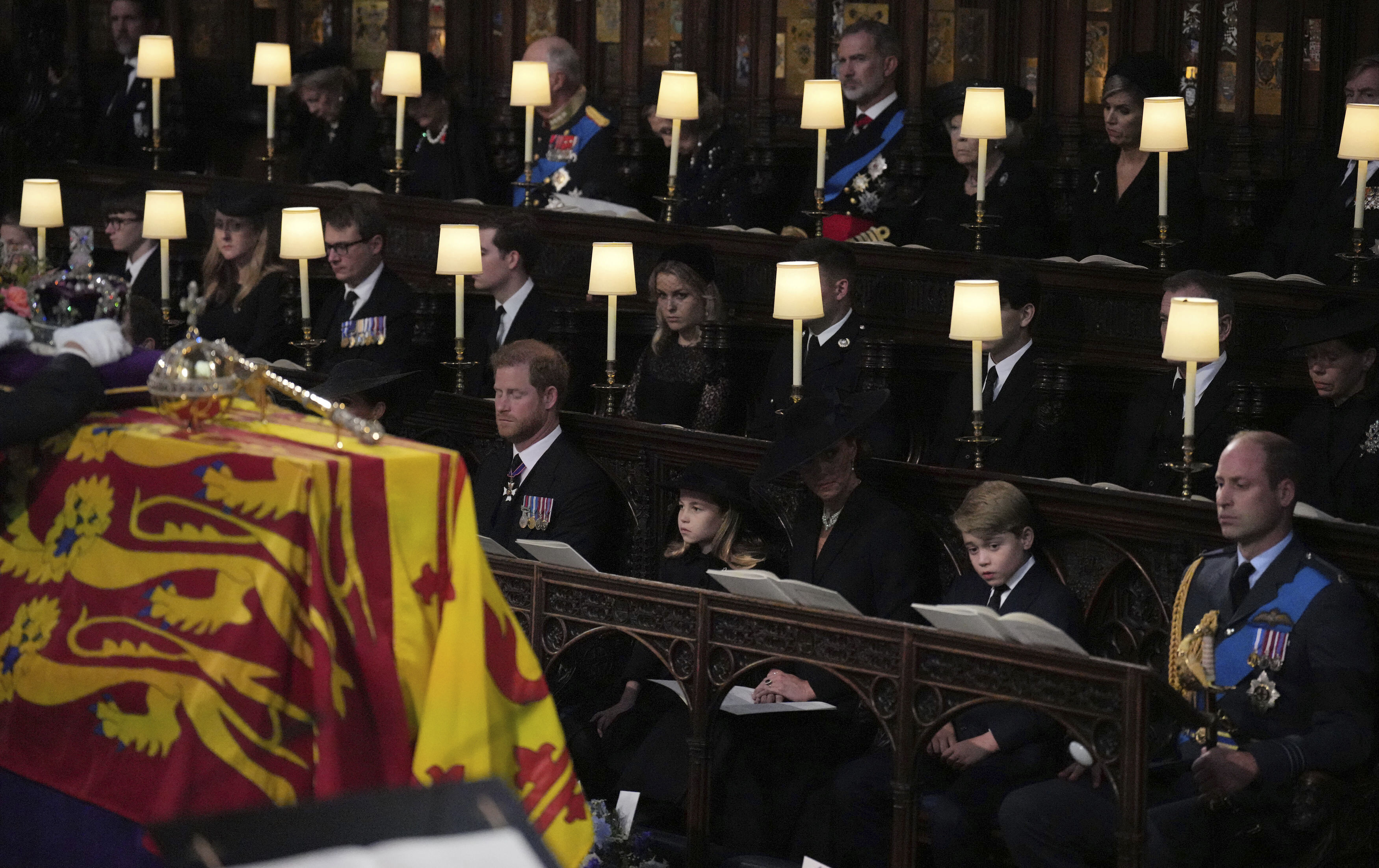 From left, Prince Harry, the Duke of Sussex, Princess Charlotte, Kate the Princess of Wales, Prince George and Prince William sit, during the committal service for Queen Elizabeth II, at St. George's Chapel, in Windsor, England, Monday Sept. 19, 2022. 