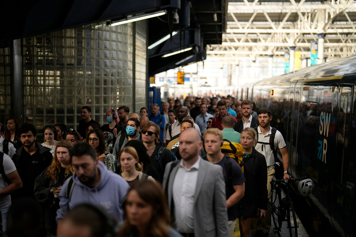 Passengers disembark from one of the few trains to arrive this morning at Waterloo railway station in London, Tuesday, June 21, 2022.