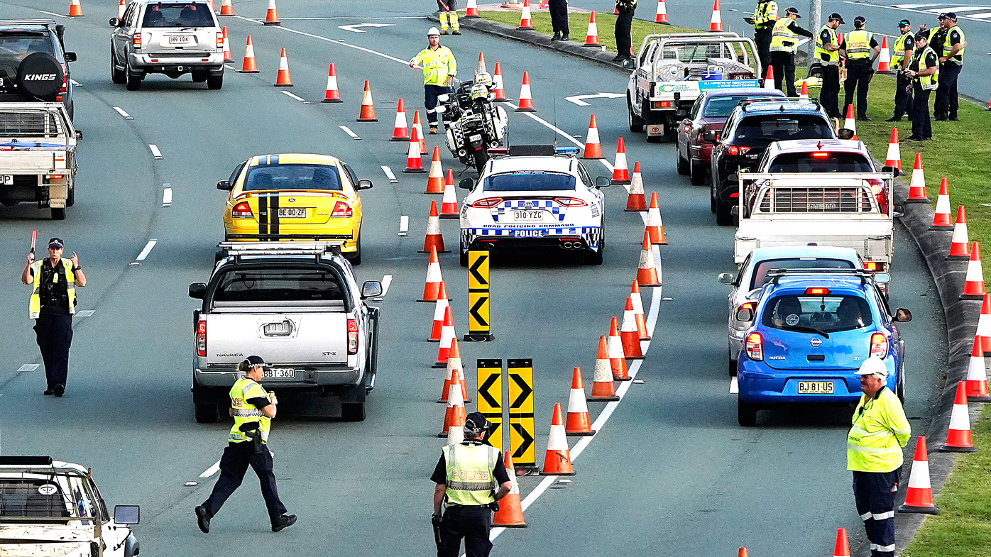 Motorists are stopped at a checkpoint on the Gold Coast Highway at Coolangatta on the Queensland/NSW border, on March 26