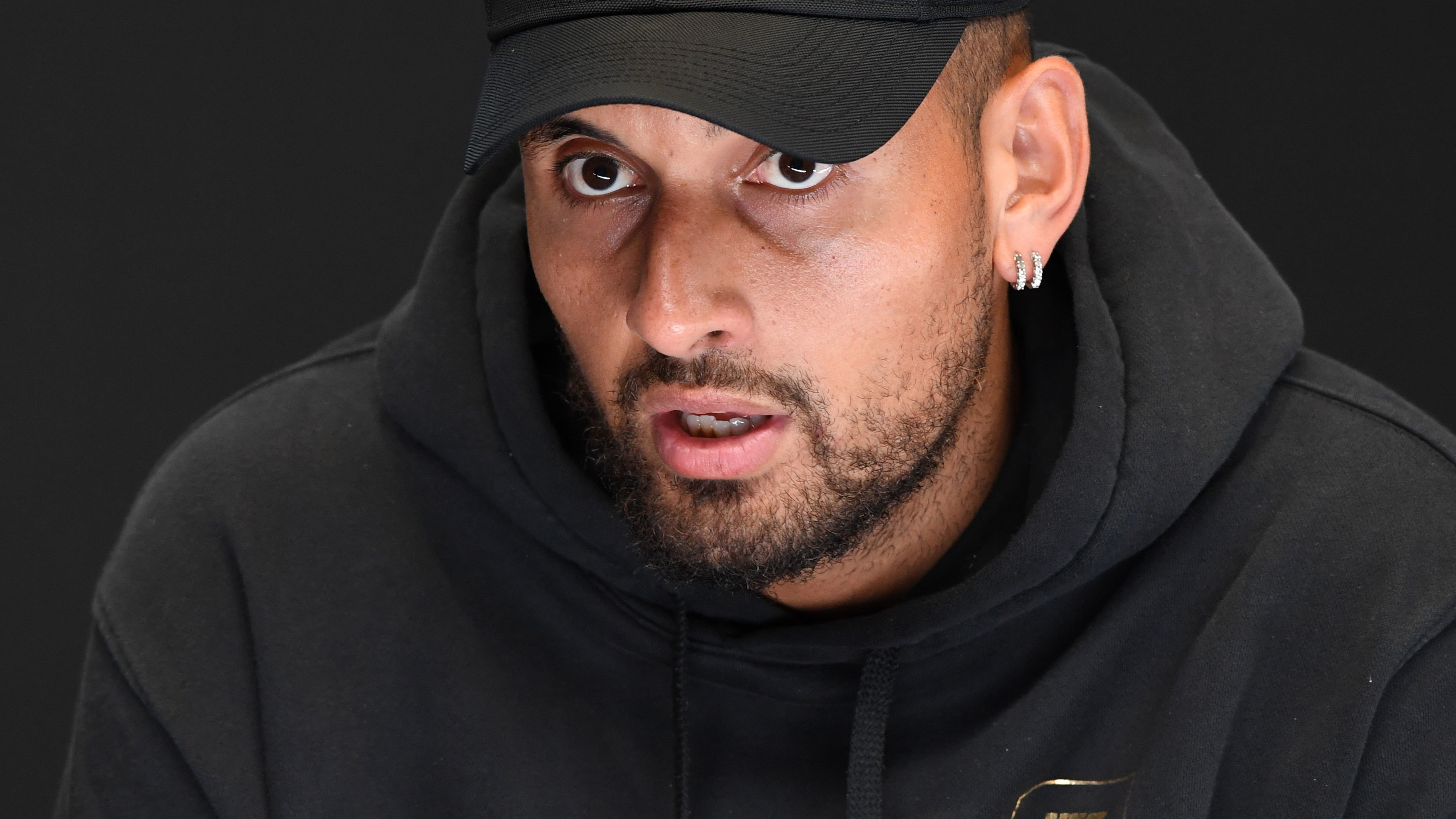 Nick Kyrgios speaks to media to announce his withdrawal from the 2023 Australian Open due to a knee injury. 