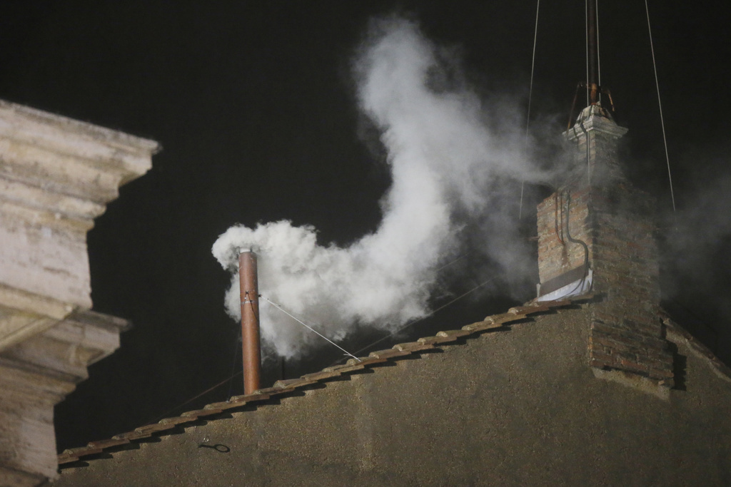White smoke is seen billowing out from the chimney of the Sistine Chapel and announcing that a new pope has been elected on March 13, 2013.