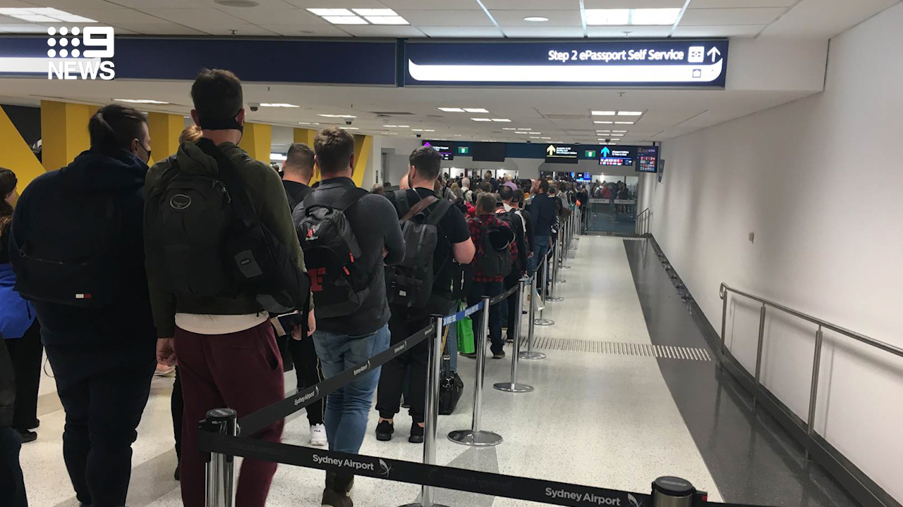 Incoming passengers at Sydney airport wait in line after tough new self-isolation measures were rolled out in Australia.
