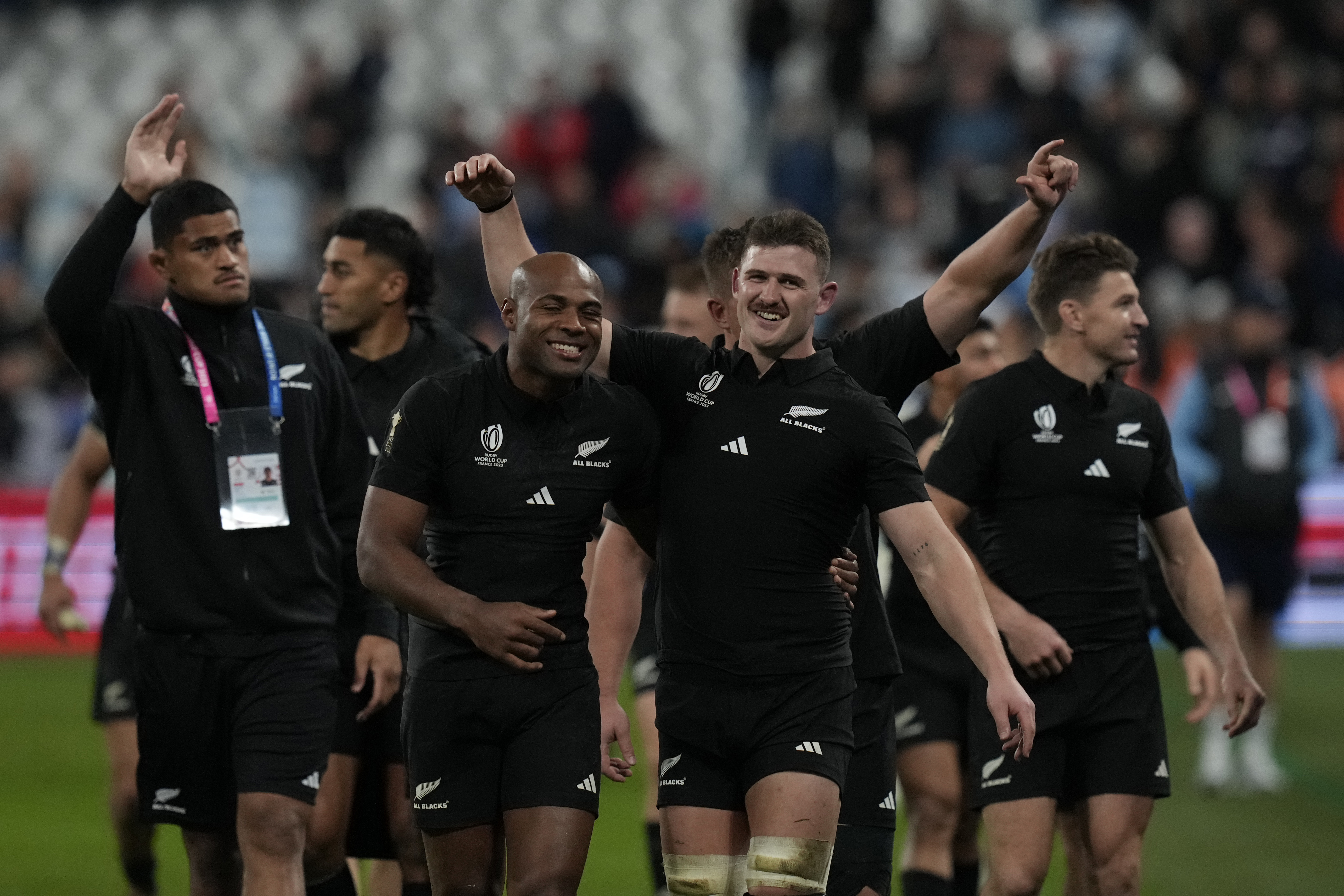 New Zealand's Mark Telea, (center left), and Dalton Papali'i celebrate after the Rugby World Cup semi-final match againt Argentina.