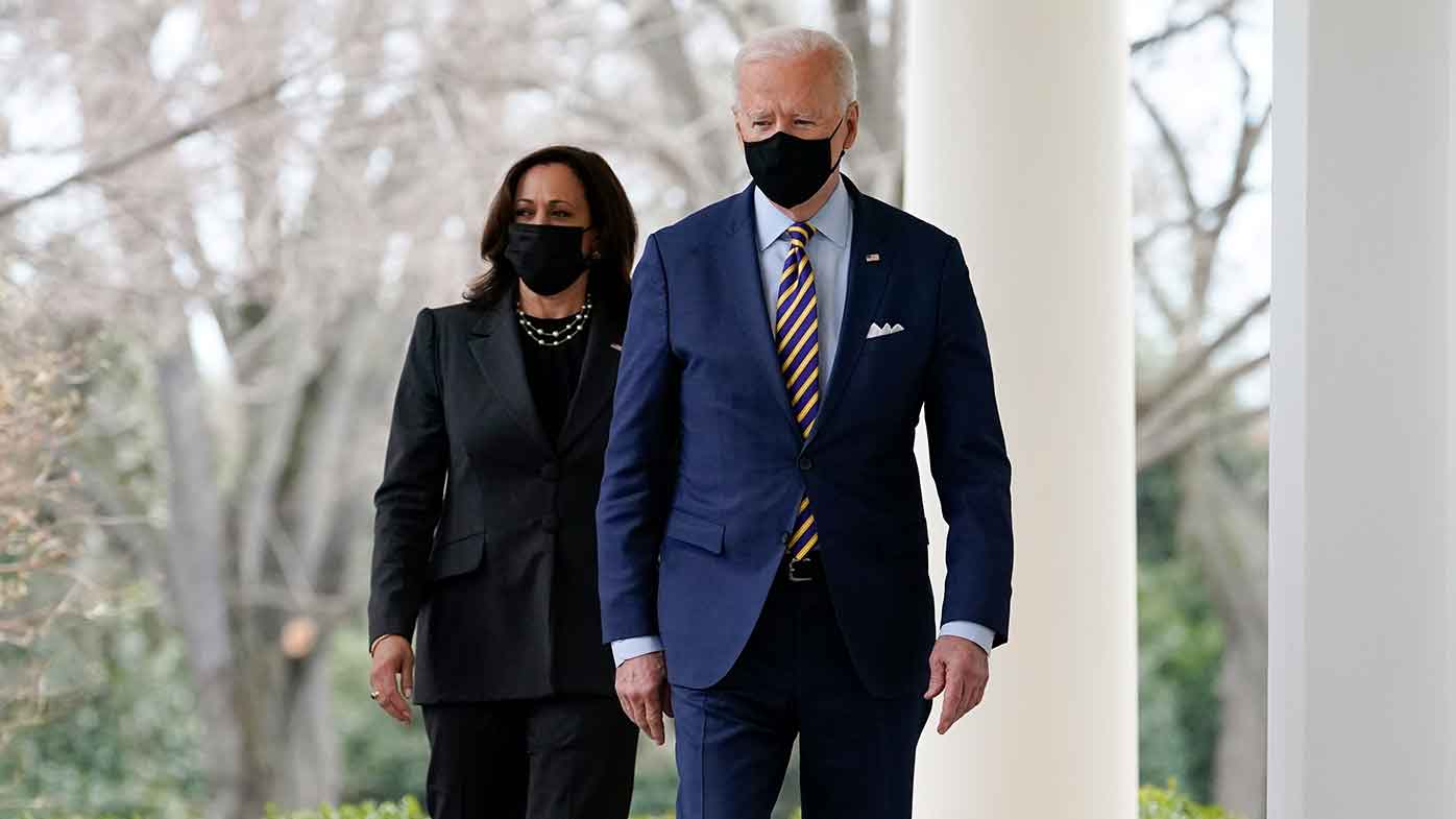 President Joe Biden and Vice President Kamala Harris walk along the White House colonnade as they arrive to speak in the Rose Garden in Washington.