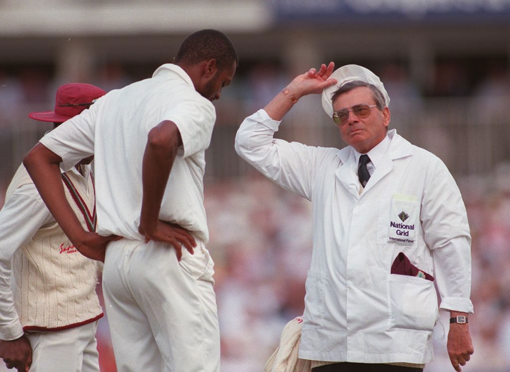 Umpire Harold 'Dickie' Bird (right) talks with Courtney Walsh of the West Indies (left).