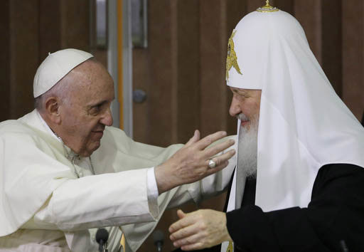 Pope Francis, left, reaches to embrace Russian Orthodox Patriarch Kirill after signing a joint declaration at the Jose Marti International airport in Havana, Cuba, Friday, Feb. 12, 2016. 