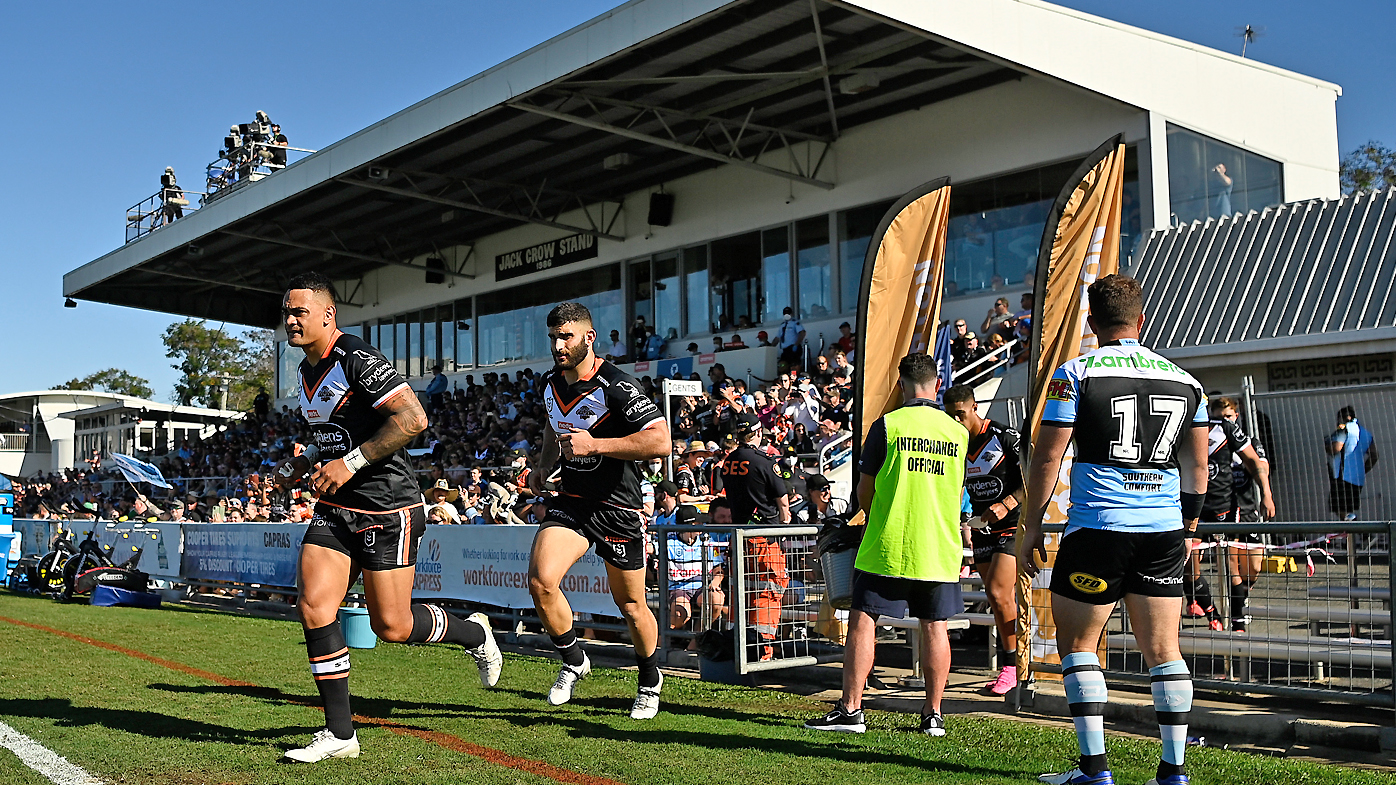 The Tigers run onto the field for the start of the round 23 NRL match between the Wests Tigers and the Cronulla Sharks at Browne Park