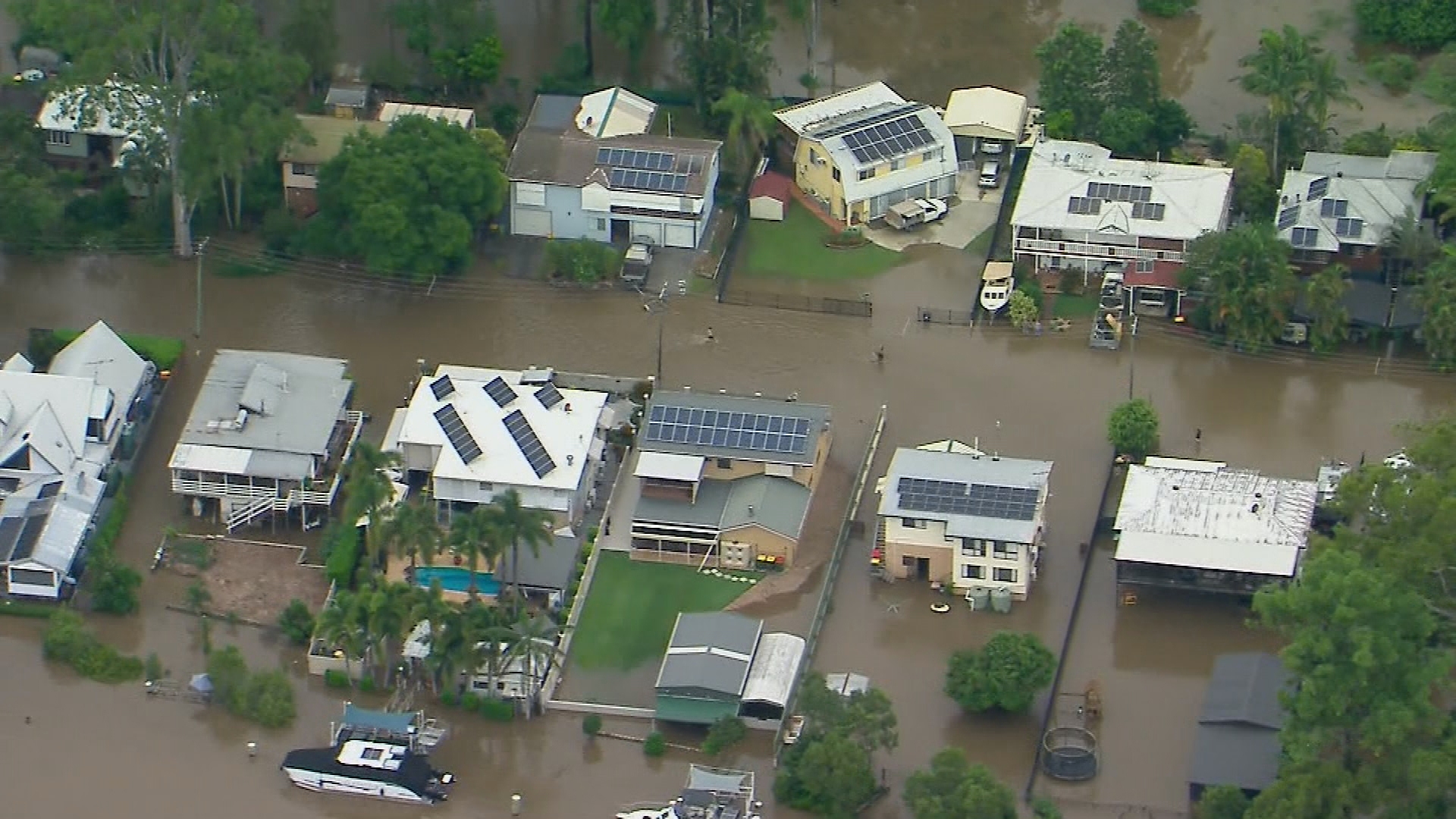 Two tradies have rescued an elderly man who became trapped in his car while it was being washed away by floodwaters in Queensland's Moreton Bay region.