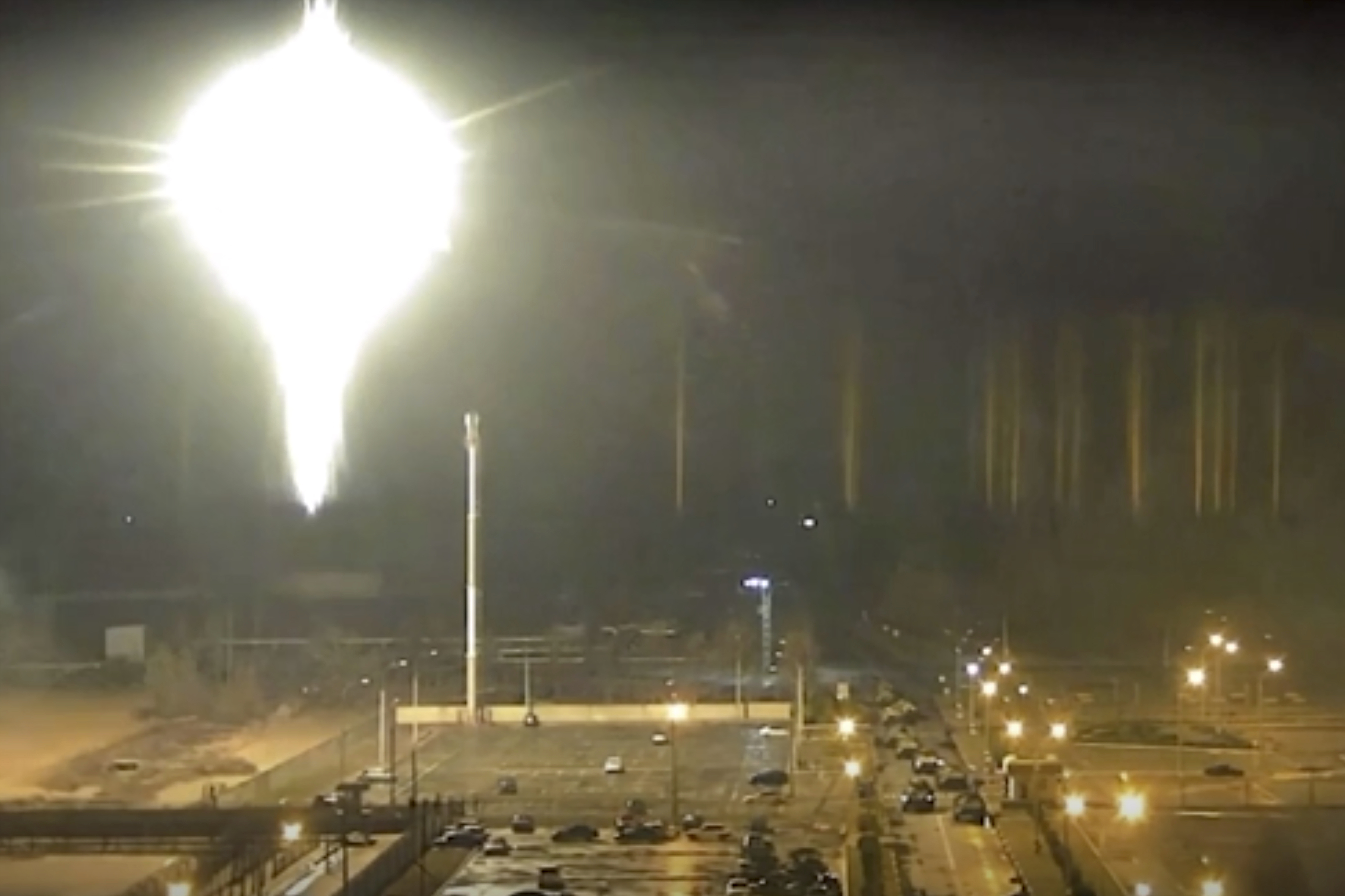 This image made from a video released by Zaporizhzhia nuclear power plant shows bright flaring object landing in grounds of the nuclear plant in Enerhodar, Ukraine Friday, March 4, 2022. 