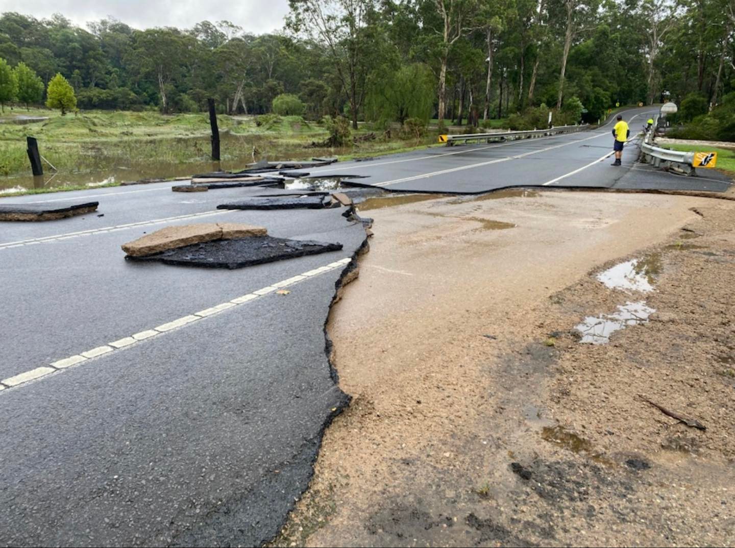 Floodwaters caused a portion of the road in north-west Sydney to wash away. 