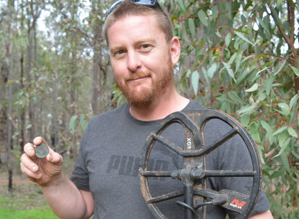 Metal detectorist Rhys Hall, pictured with a love token made by Stephen Stanley Parker - one of West Australia's first white settlers - in 1837.