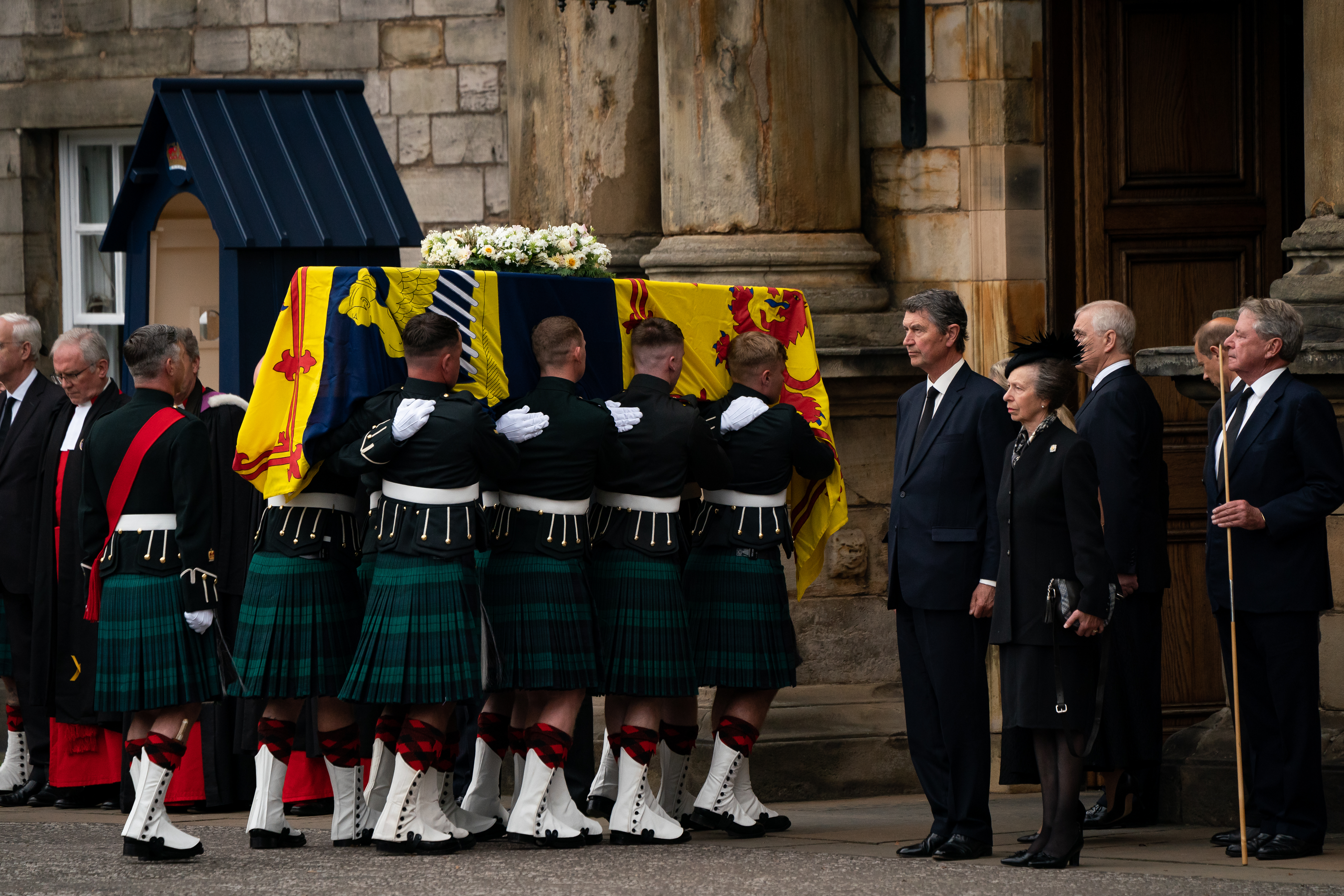 EDINBURGH, SCOTLAND - SEPTEMBER 11:  Vice Admiral Timothy Laurence and Britain's Princess Anne, Princess Royal stand solemnly as the coffin of Queen Elizabeth II, draped with the Royal Standard of Scotland, completes its journey from Balmoral to the Palace of Holyroodhouse on September 11, 2022 in Edinburgh, United Kingdom. Elizabeth Alexandra Mary Windsor was born in Bruton Street, Mayfair, London on 21 April 1926. She married Prince Philip in 1947 and ascended the throne of the United Kingdom 
