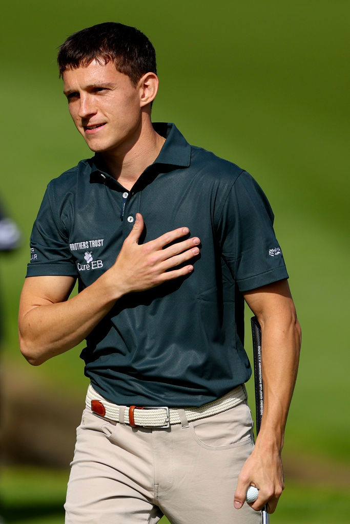 VIRGINIA WATER, ENGLAND - SEPTEMBER 18: Tom Holland acknowledges the crowd on the 18th green during the Pro-Am prior to the BMW PGA Championship 2024 at Wentworth Club on September 18, 2024 in Virginia Water, England. (Photo by Andrew Redington/Getty Images)