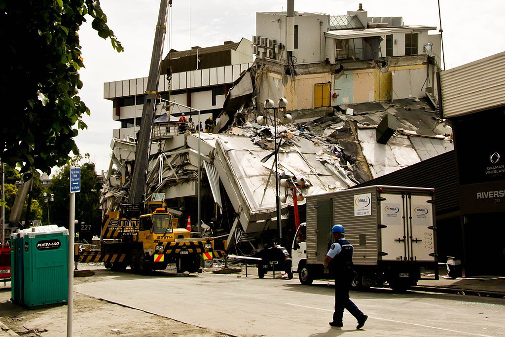 A policeman walks past a building destroyed by the 2011 Christchurch earthquake.