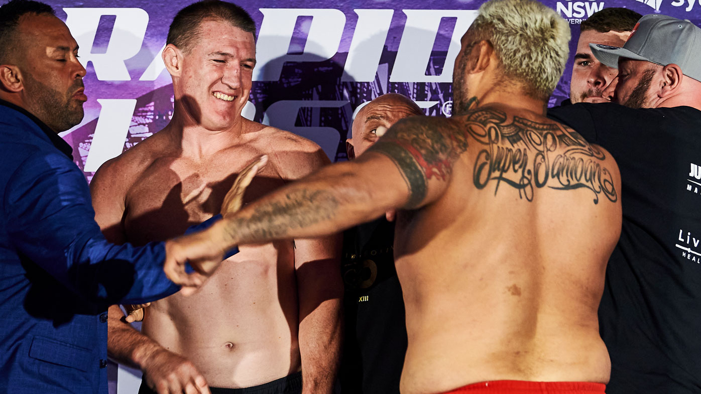 Mark Hunt takes a swing at Paul Gallen at their weigh-in. (Getty)