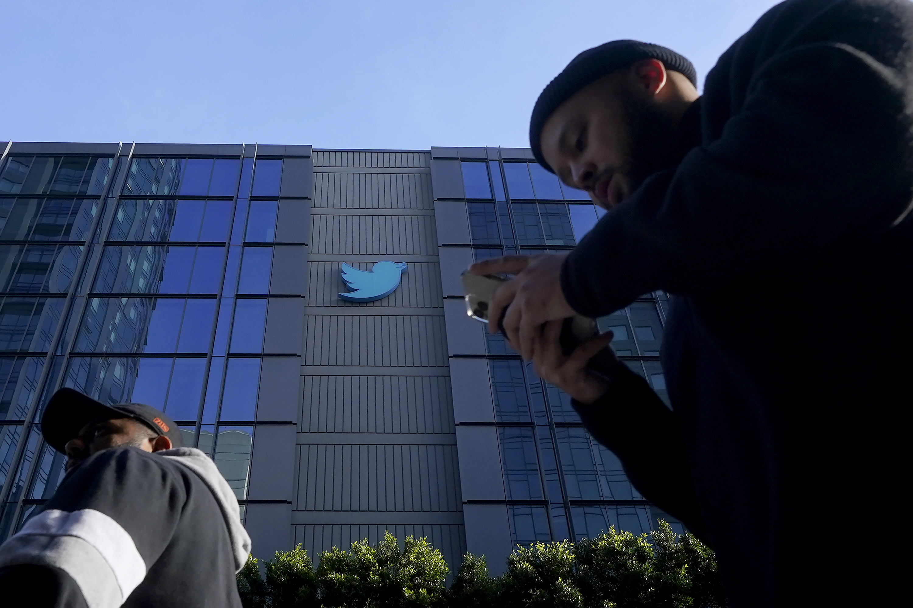 People walk outside Twitter headquarters in San Francisco, Friday, Nov. 4, 2022. 