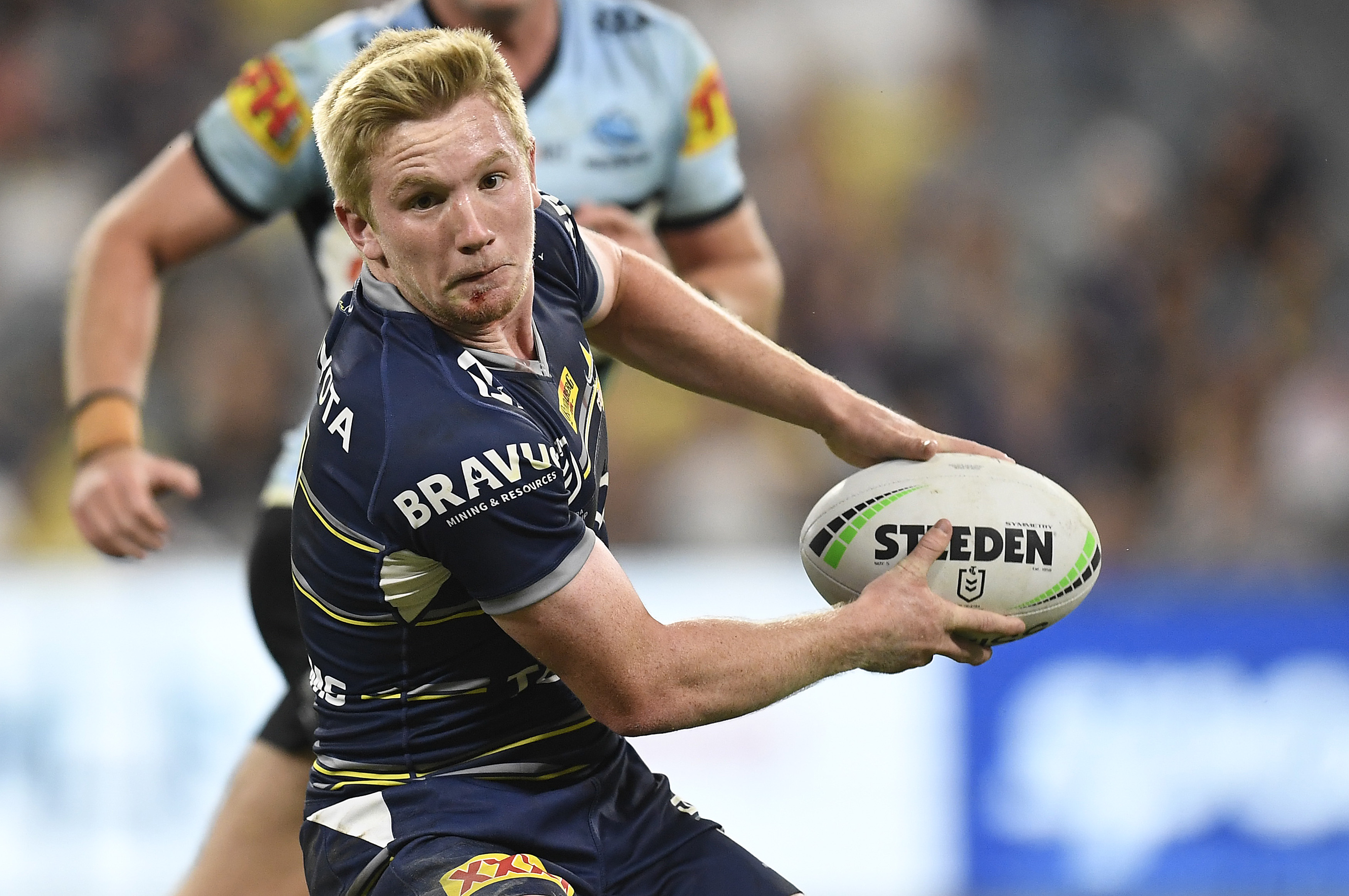 Tom Dearden of the Cowboys runs the ball against the Cronulla Sharks.