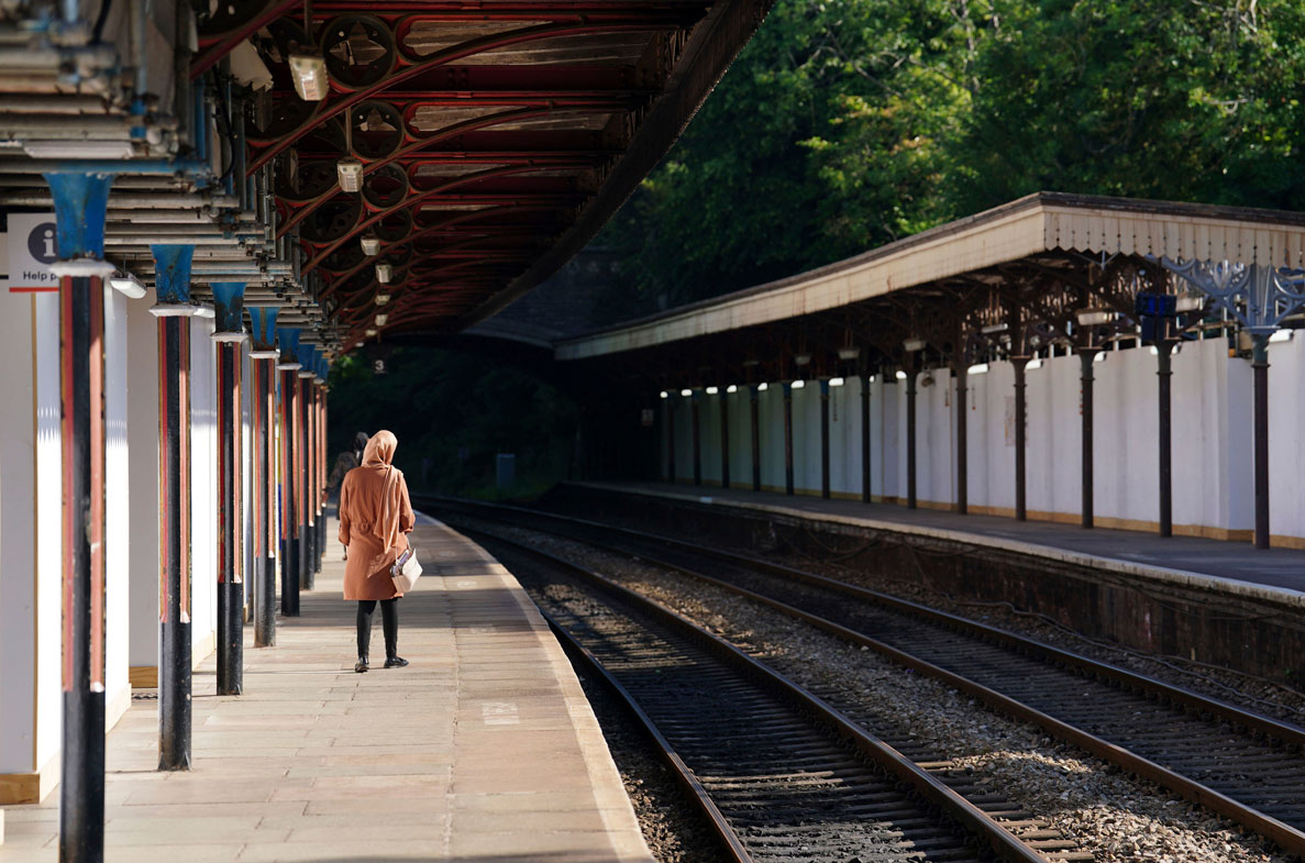 A passenger waits at Great Malvern train station as members of the Rail, Maritime and Transport union begin their nationwide strike, in Worcester, England, Tuesday June 21, 2022. 
