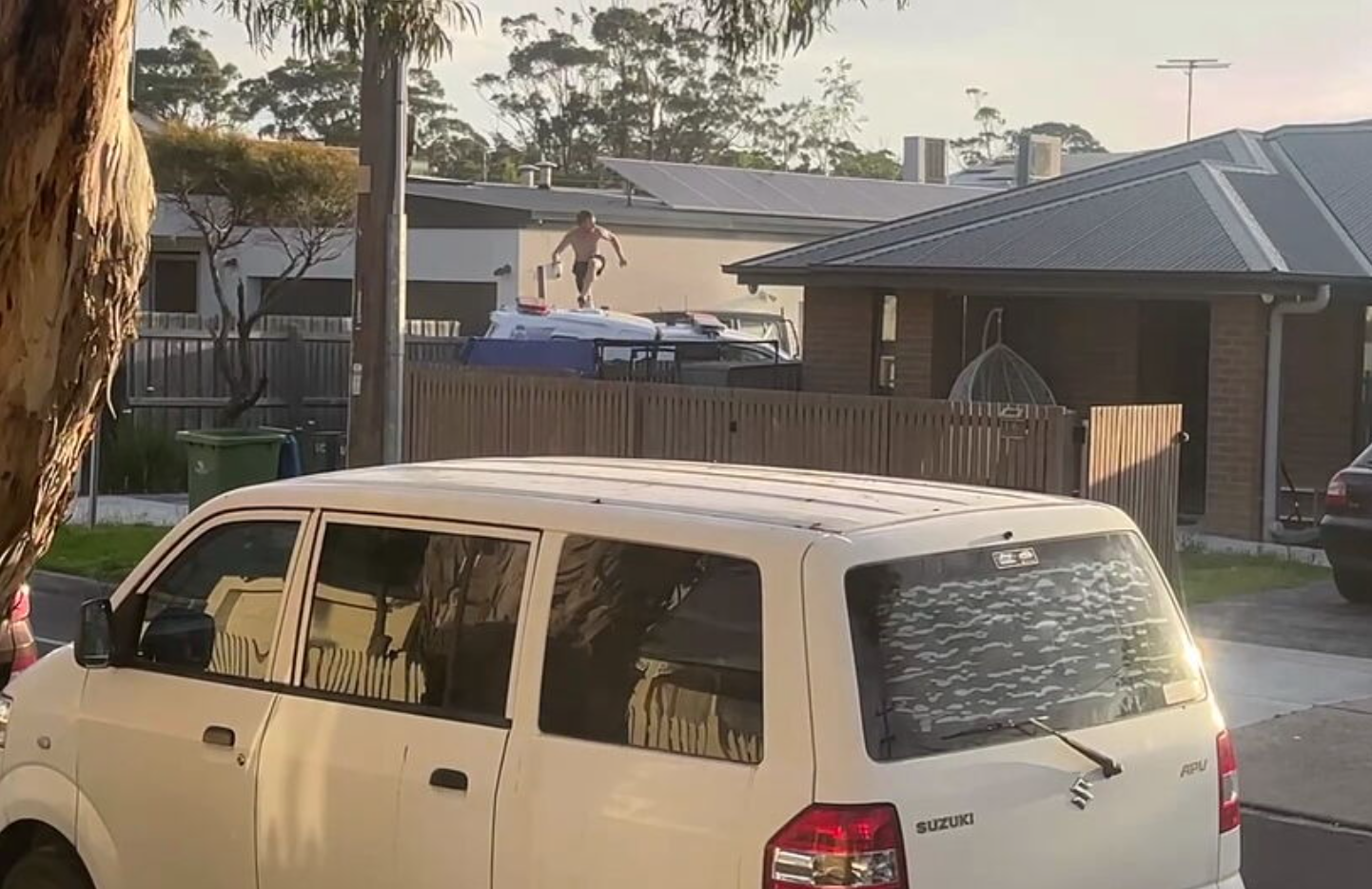 The man was seen leaping from the top of the police car onto the footpath as he fled the scene.