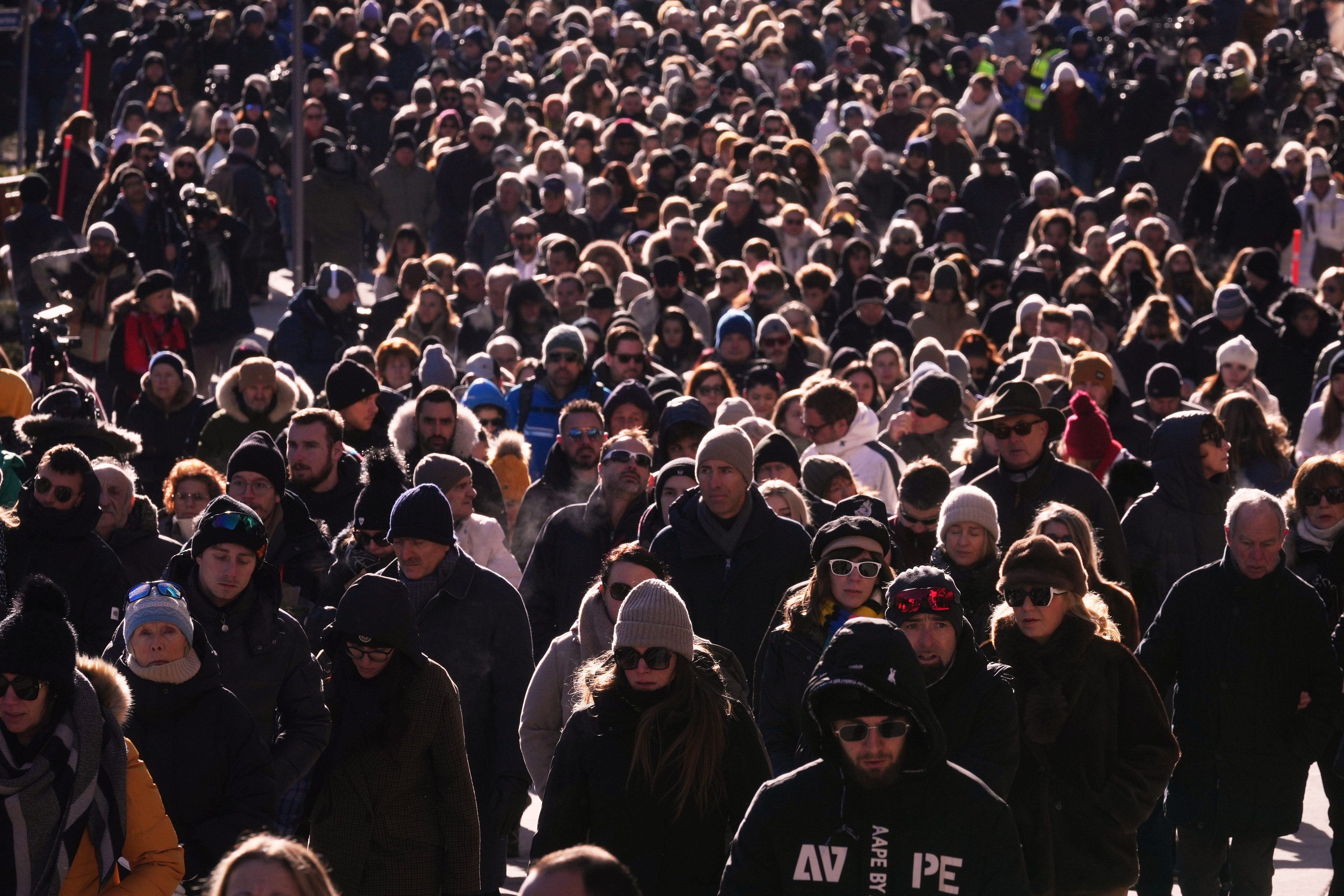 People walk during a memorial procession in Crans-Montana, Swiss Alps, Switzerland, Sunday, Jan. 4, 2026, after a devastating fire in Le Constellation bar left dead and injured during the New Year's celebrations. (AP Photo/ Antonio Calanni)
