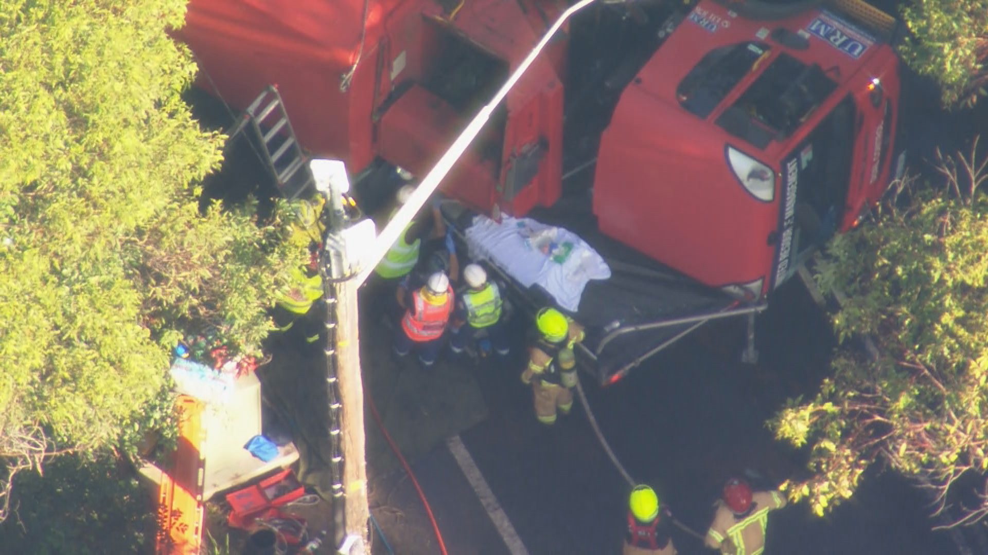Driver trapped after truck rolls onto ute in Sydney's north