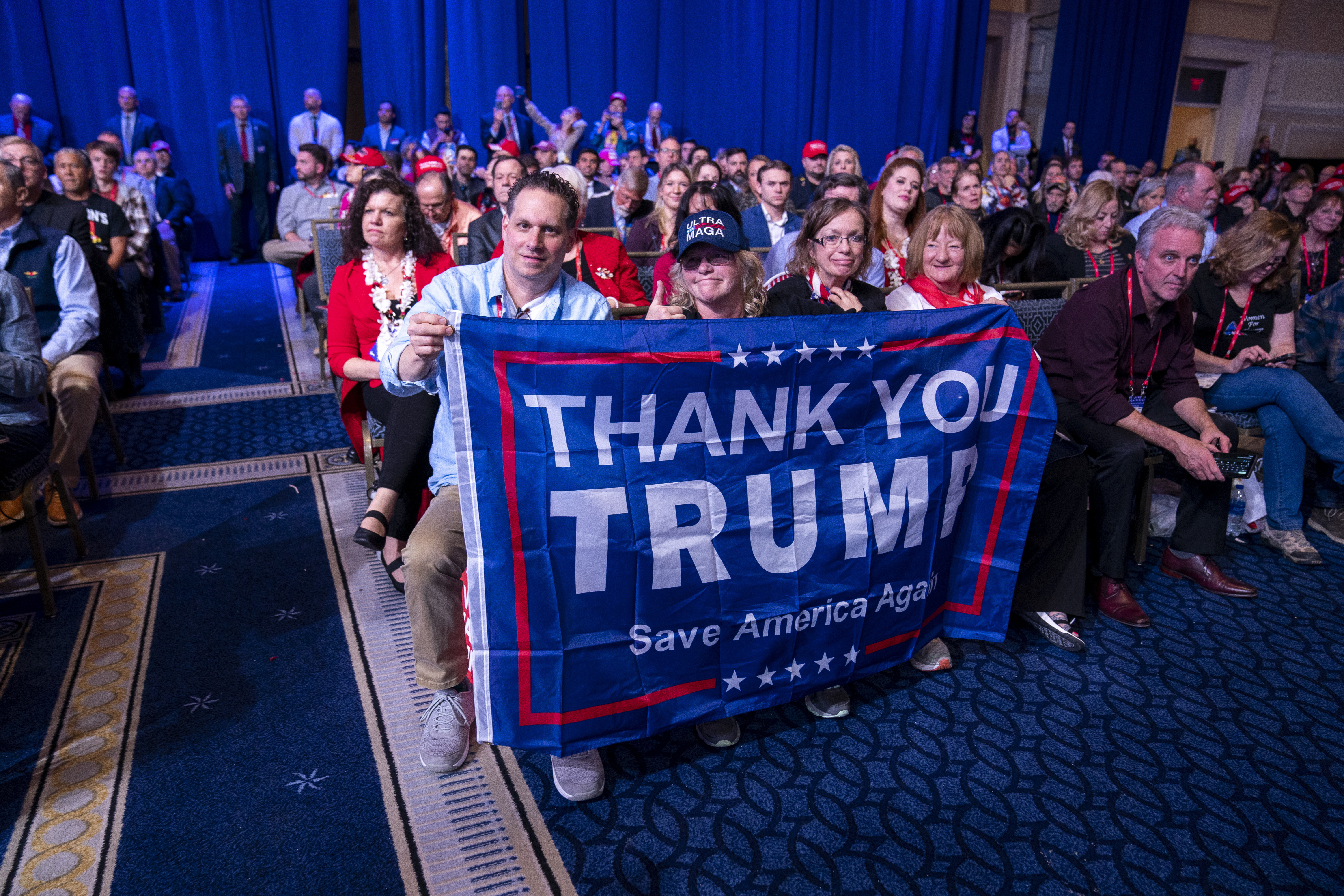 Supporters hold a flag as former President Donald Trump speaks at the Conservative Political Action Conference, CPAC 2023, Saturday, March 4, 2023, at National Harbor in Oxon Hill, Md. (AP Photo/Alex Brandon)