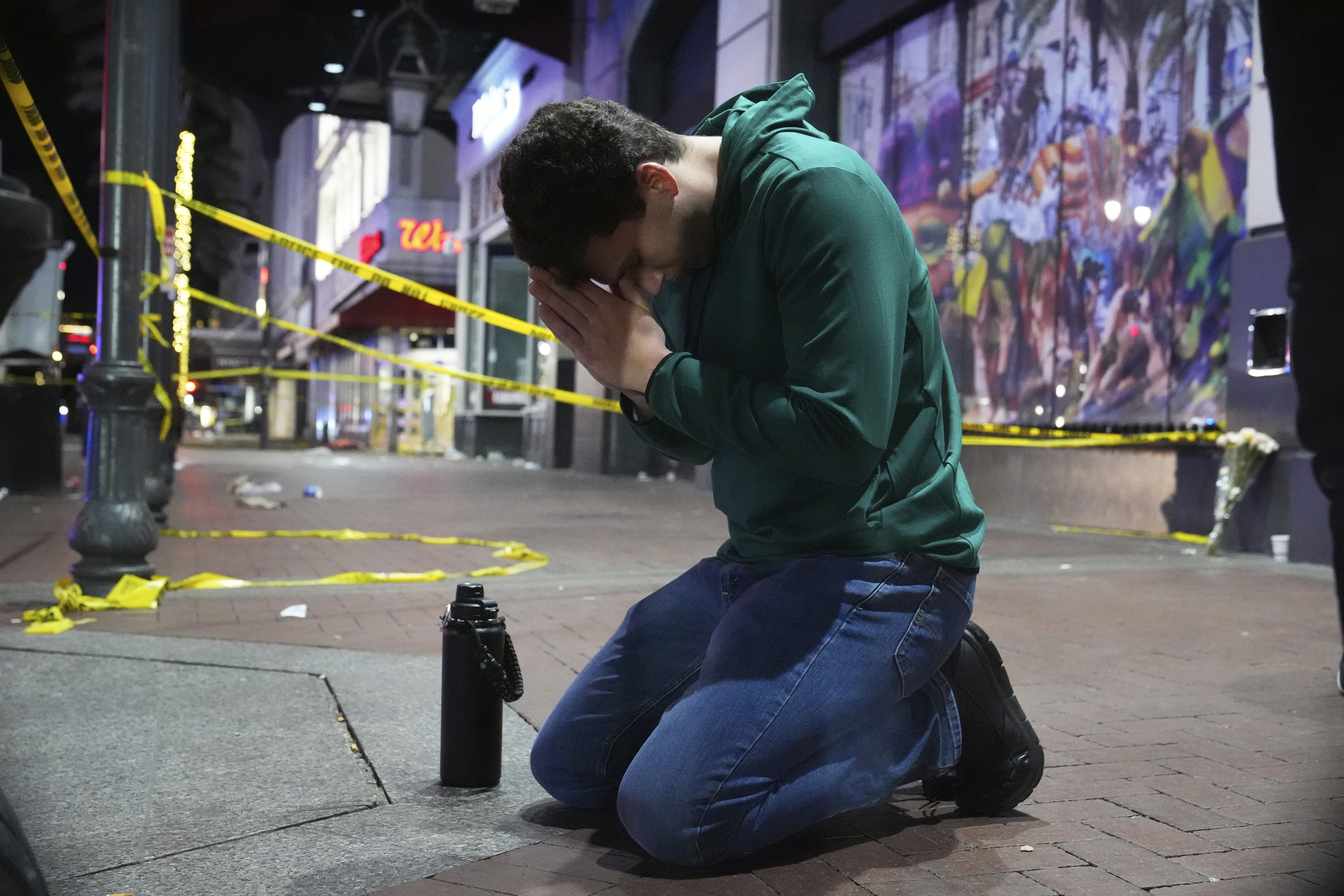 Matthias Hauswirth de Nueva Orleans ora en la calle cerca del lugar donde un vehículo atropelló a una multitud en las calles Canal y Bourbon de Nueva Orleans.