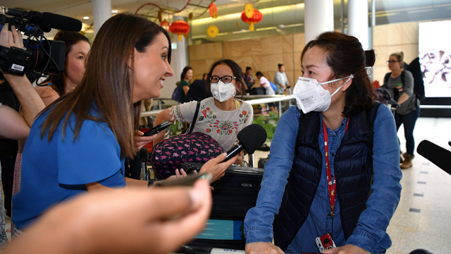 Passengers wearing protective masks arrive at Sydney International Airport on January 23. Australia is working to keep out the deadly coronavirus, as a flight from the Chinese city at the centre of the outbreak arrives in Sydney.