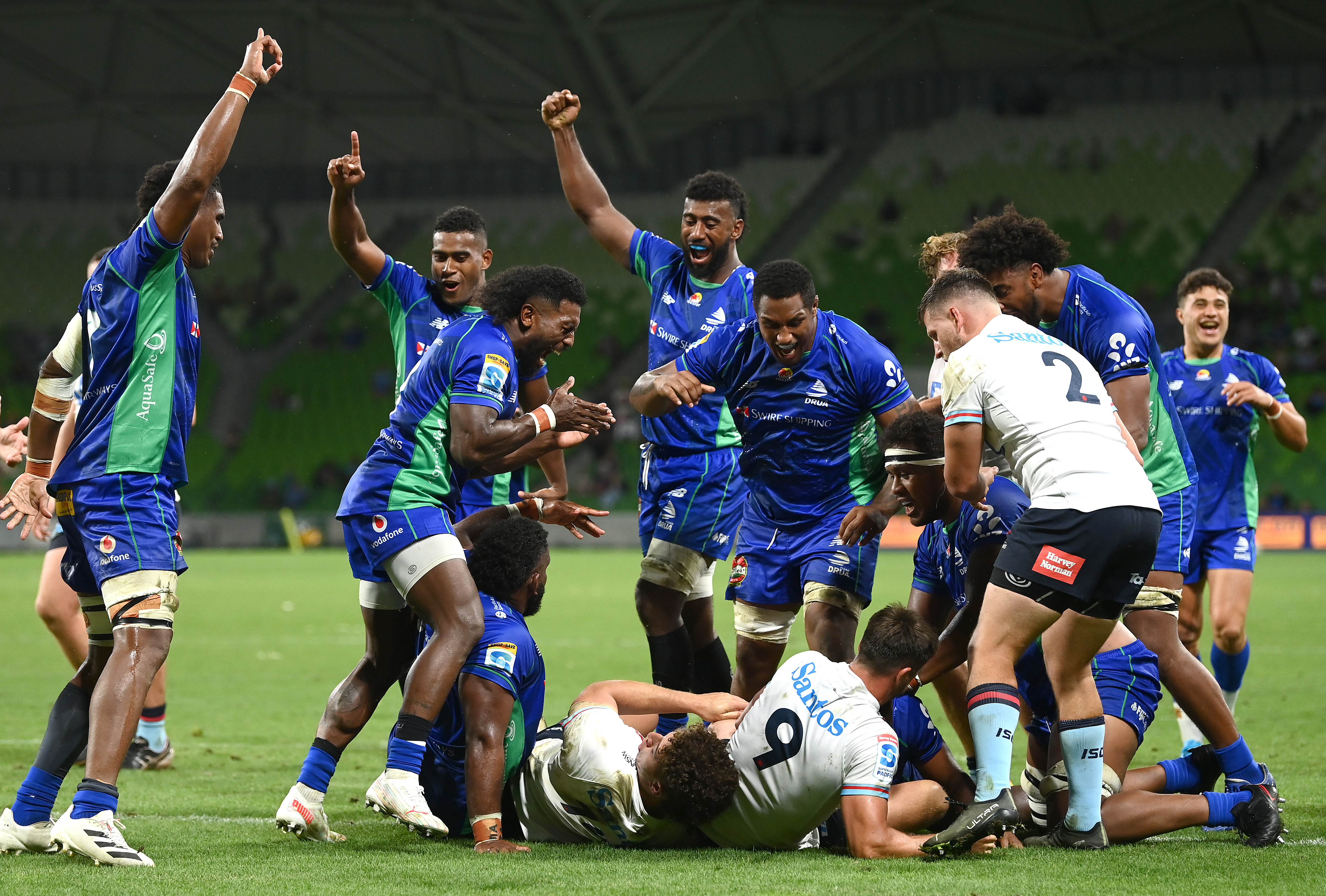 Fijian Drua celebrate scoring a try.