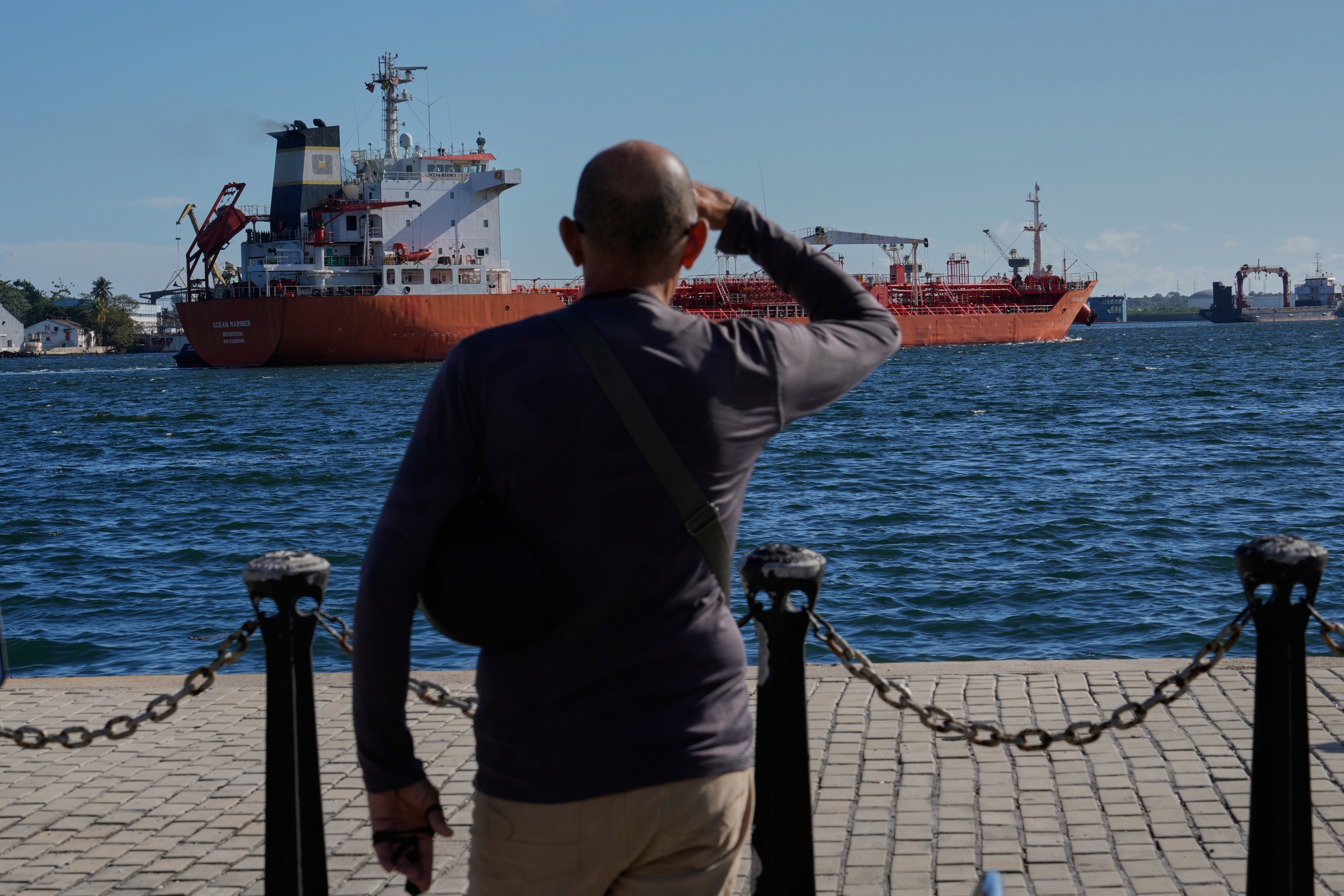 A person watches the oil tanker Ocean Mariner, Monrovia, arrive to the bay in Havana, Cuba, Friday, Jan. 9, 2026.