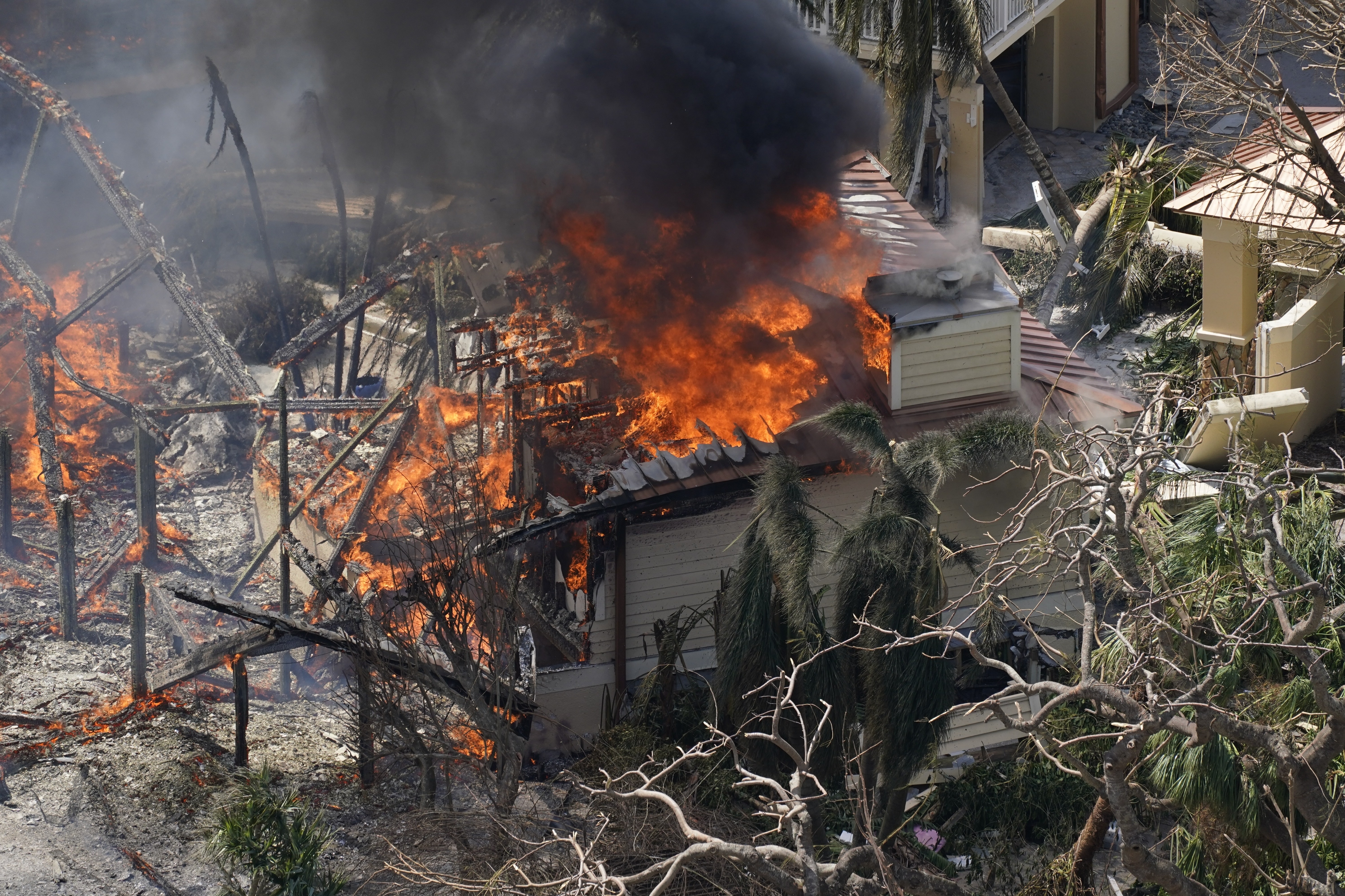 A home burns on Sanibel Island in the wake of Hurricane Ian, Thursday, Sept. 29, 2022, in Fla. (AP Photo/Wilfredo Lee)