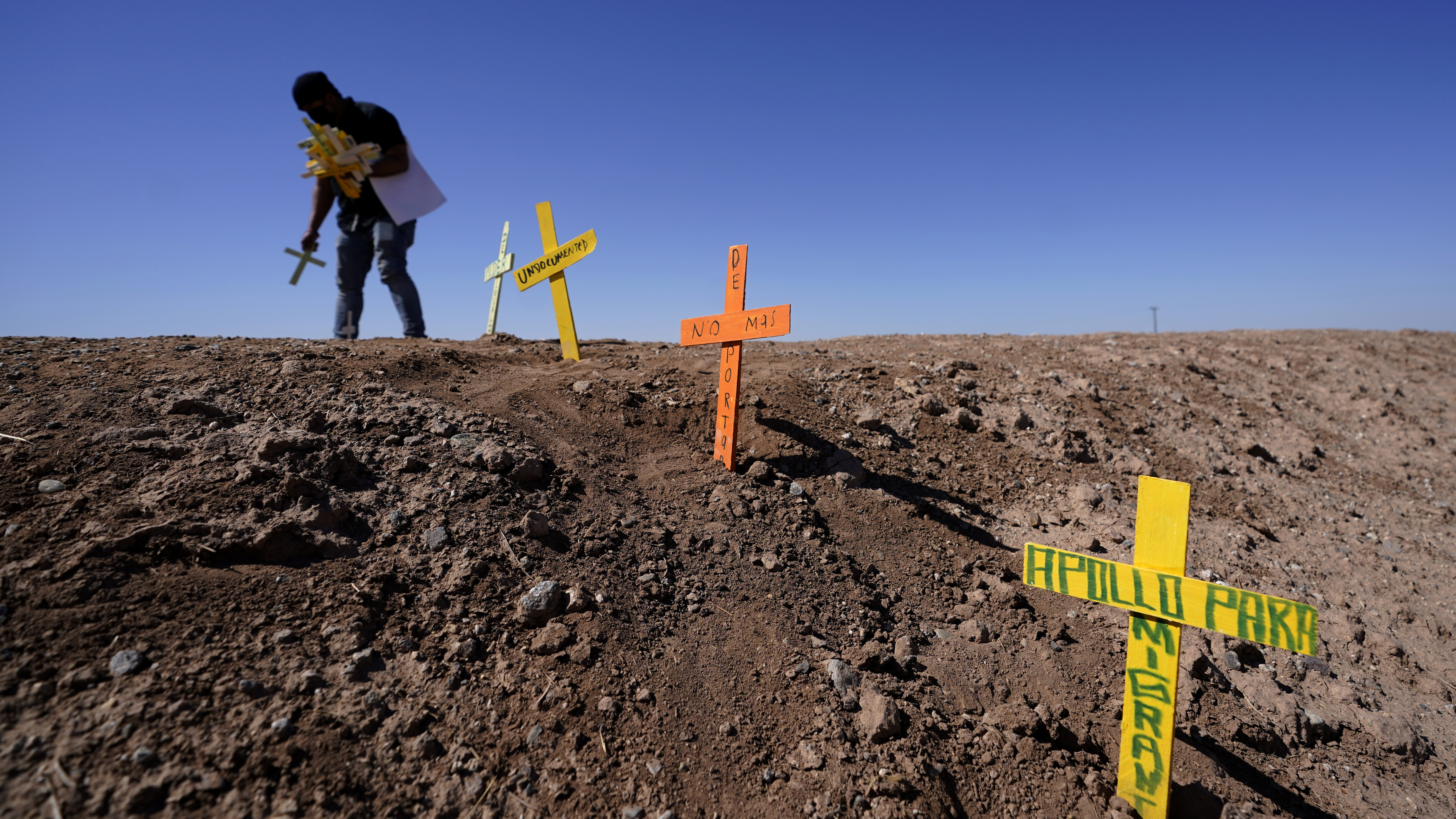 Hugo Castro leaves crosses at the scene of a deadly crash.