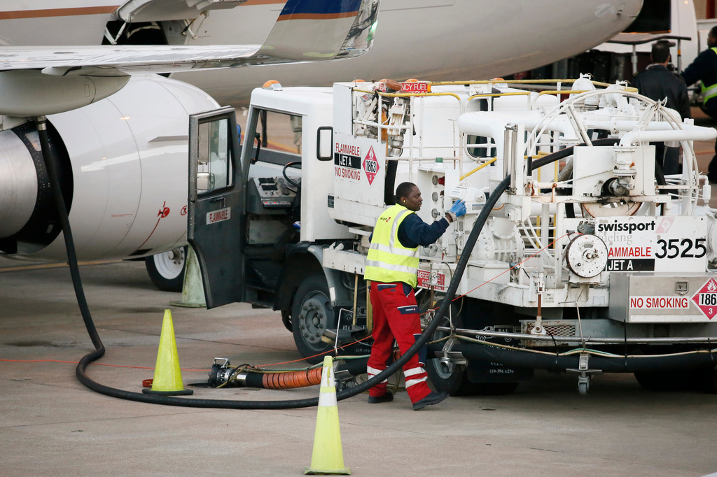 A worker prepares to fuel a United Express aircraft after it arrived at a gate at Dallas-Fort Worth International Airport.