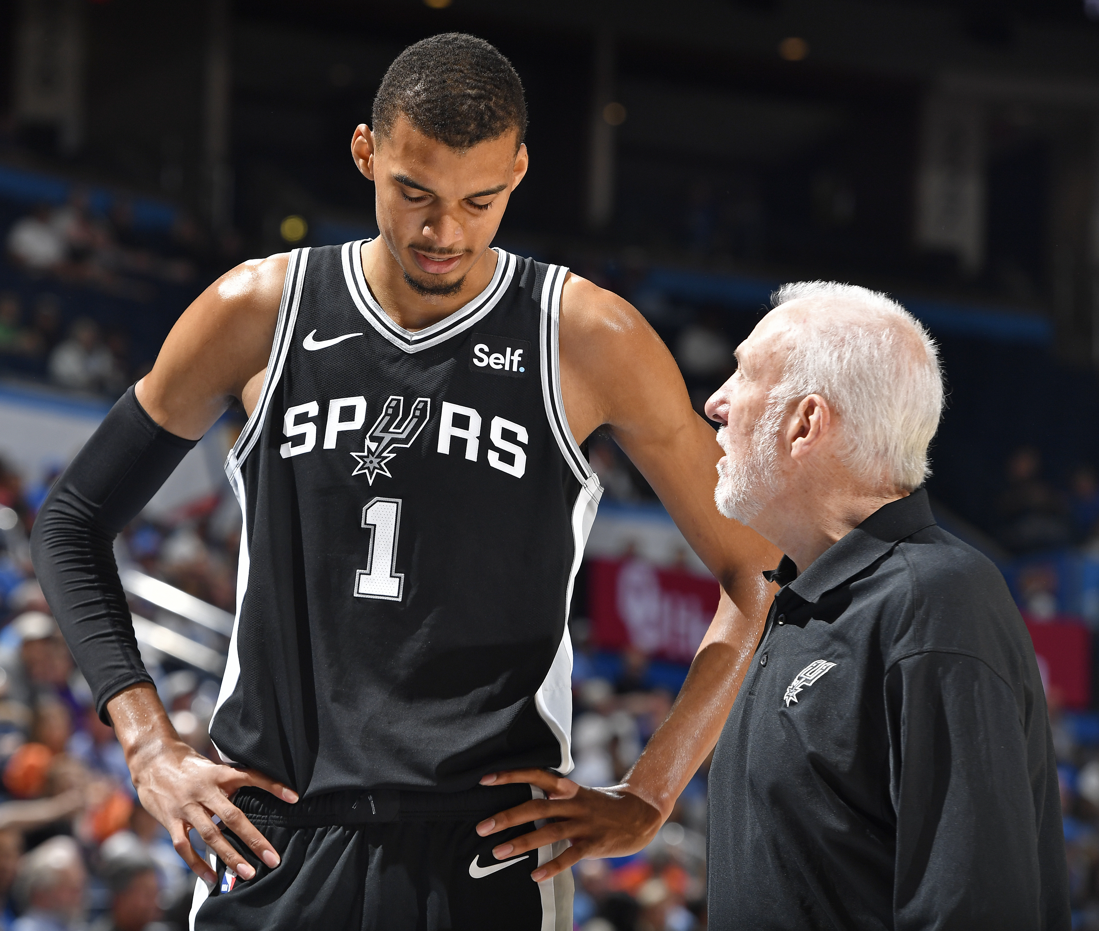 OKLAHOMA CITY, OK - OCTOBER 9: Victor Wembanyama #1 talks to Head Coach Gregg Popovich of the San Antonio Spurs during the game against the Oklahoma City Thunder on October 9, 2023 at the Paycom Center in Oklahoma City, OK. 