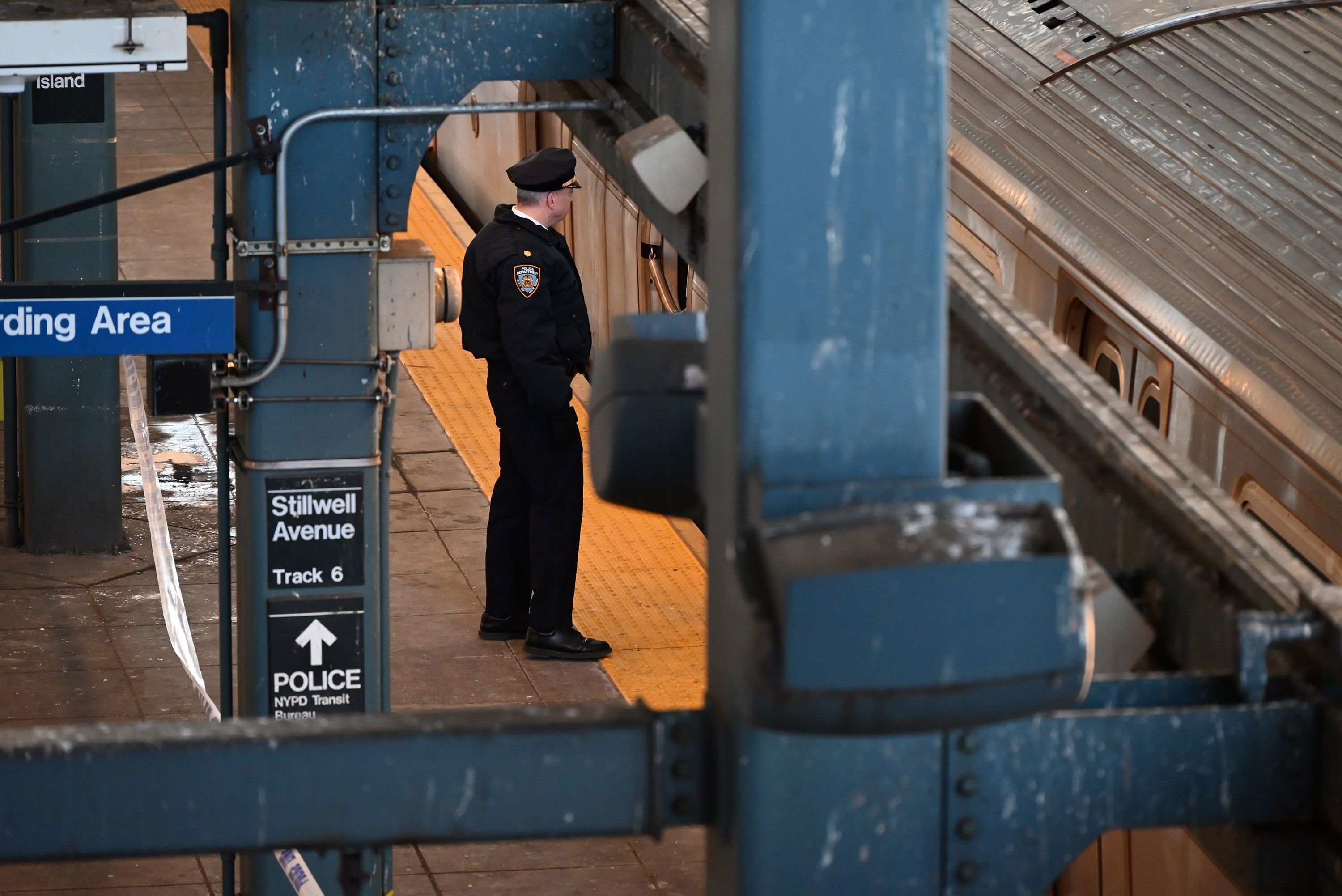 Police investigate at the Coney Island-Stillwell Avenue Station in Brooklyn after a woman aboard a subway car was set on fire and died in New York on Sunday.