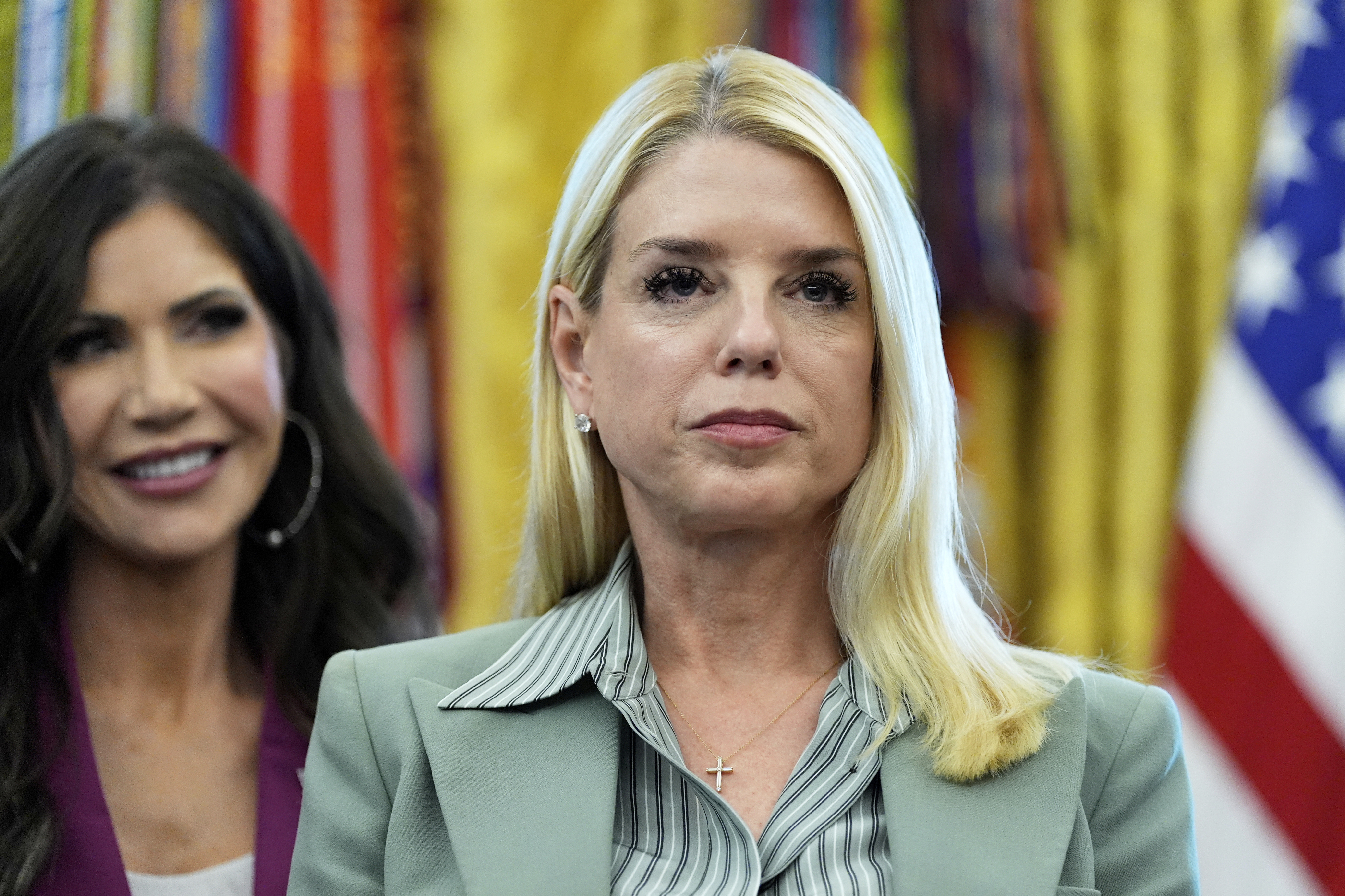 Attorney General Pam Bondi, right, and Homeland Security Secretary Kristi Noem listen as President Donald Trump speaks in the Oval Office of the White House, Monday, Sept. 15, 2025, in Washington. (AP Photo/Alex Brandon)