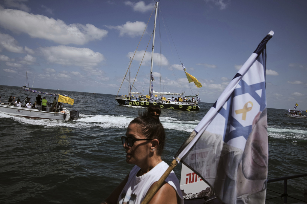Relatives of Israeli hostages held by Hamas sail along the coast of the Israel