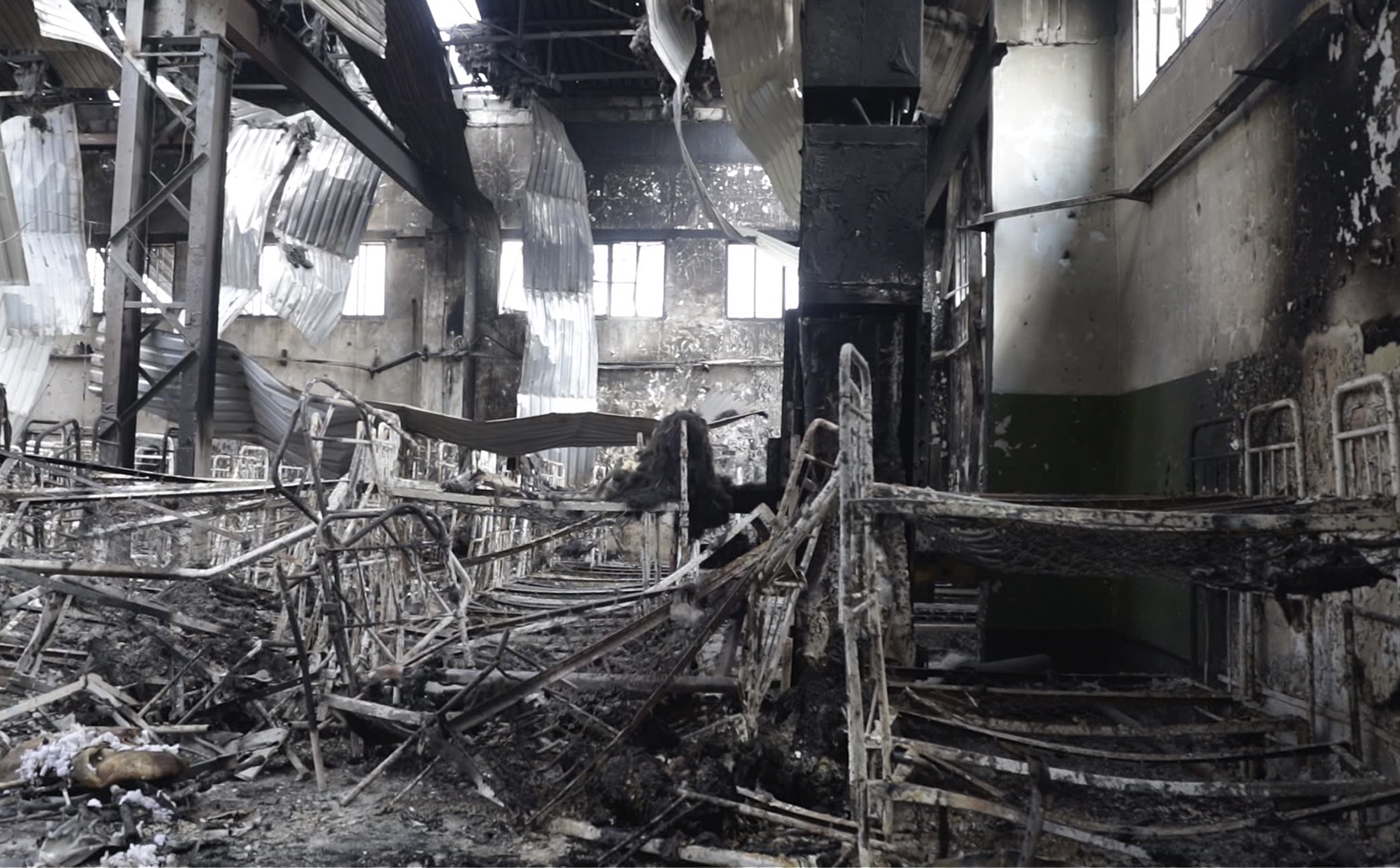 In this photo taken from video a view of destroyed barrack at a prison in Olenivka, in an area controlled by Russian-backed separatist forces, eastern Ukraine, Friday, July 29, 2022. Russia and Ukraine accused each other Friday of shelling a prison in a separatist region of eastern Ukraine, an attack that reportedly killed dozens of Ukrainian military prisoners who were captured after the fall of a southern port city of Mariupol in May. (AP Photo)