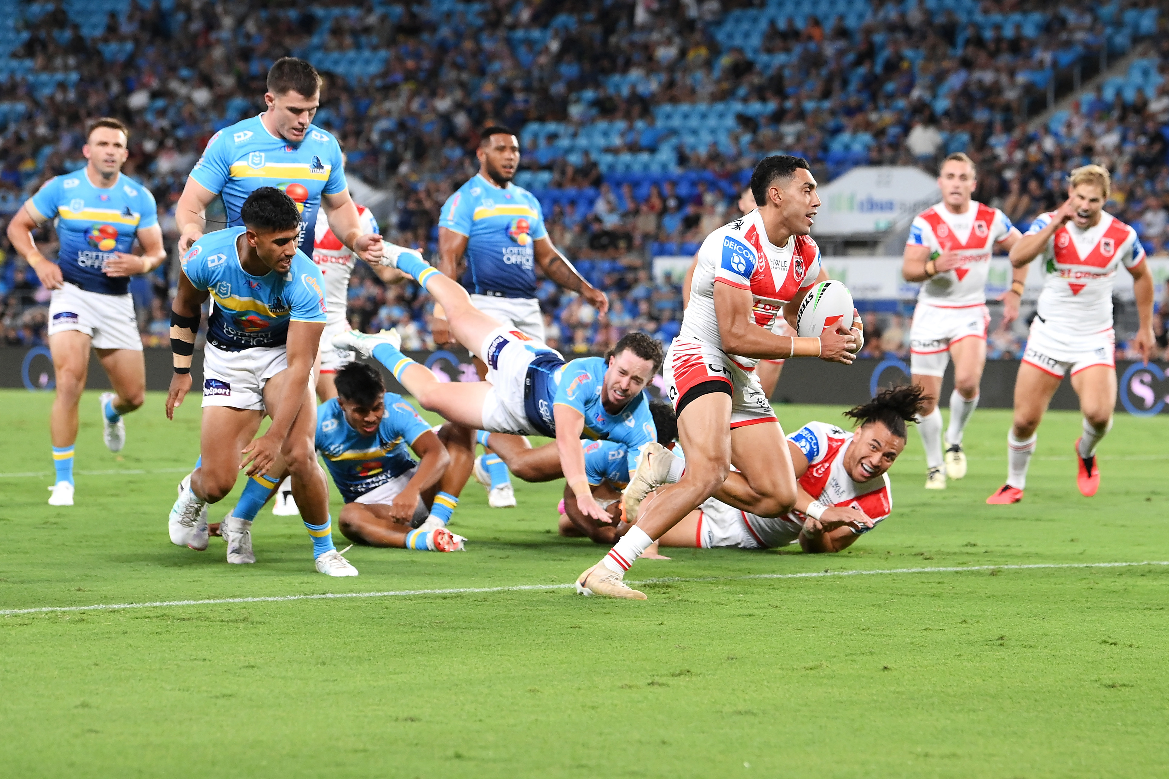 Tyrell Sloan breaks away to score a try during the round one NRL match between the Gold Coast Titans and the St George Illawarra Dragons.