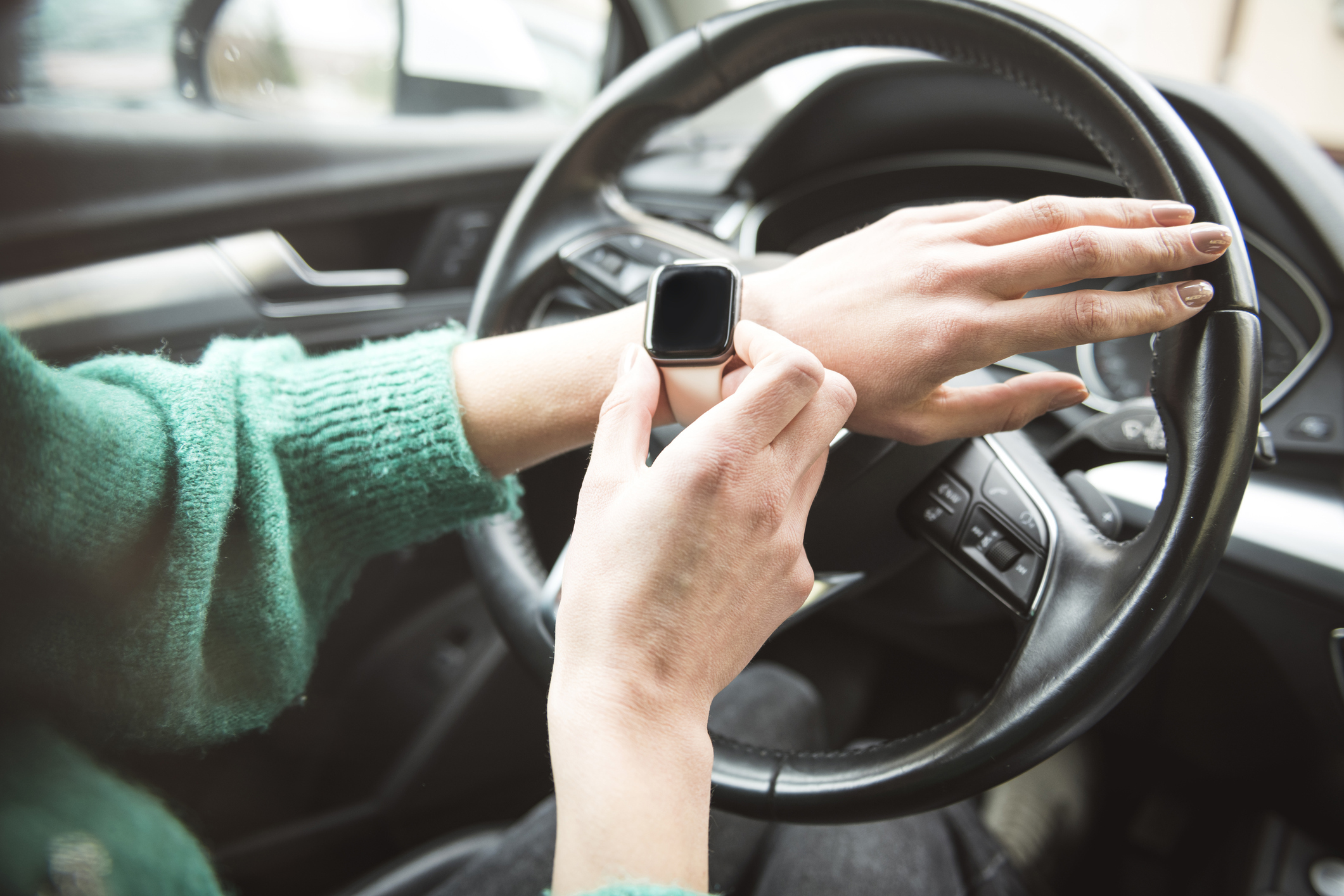 Woman using a smart watch in car. close up