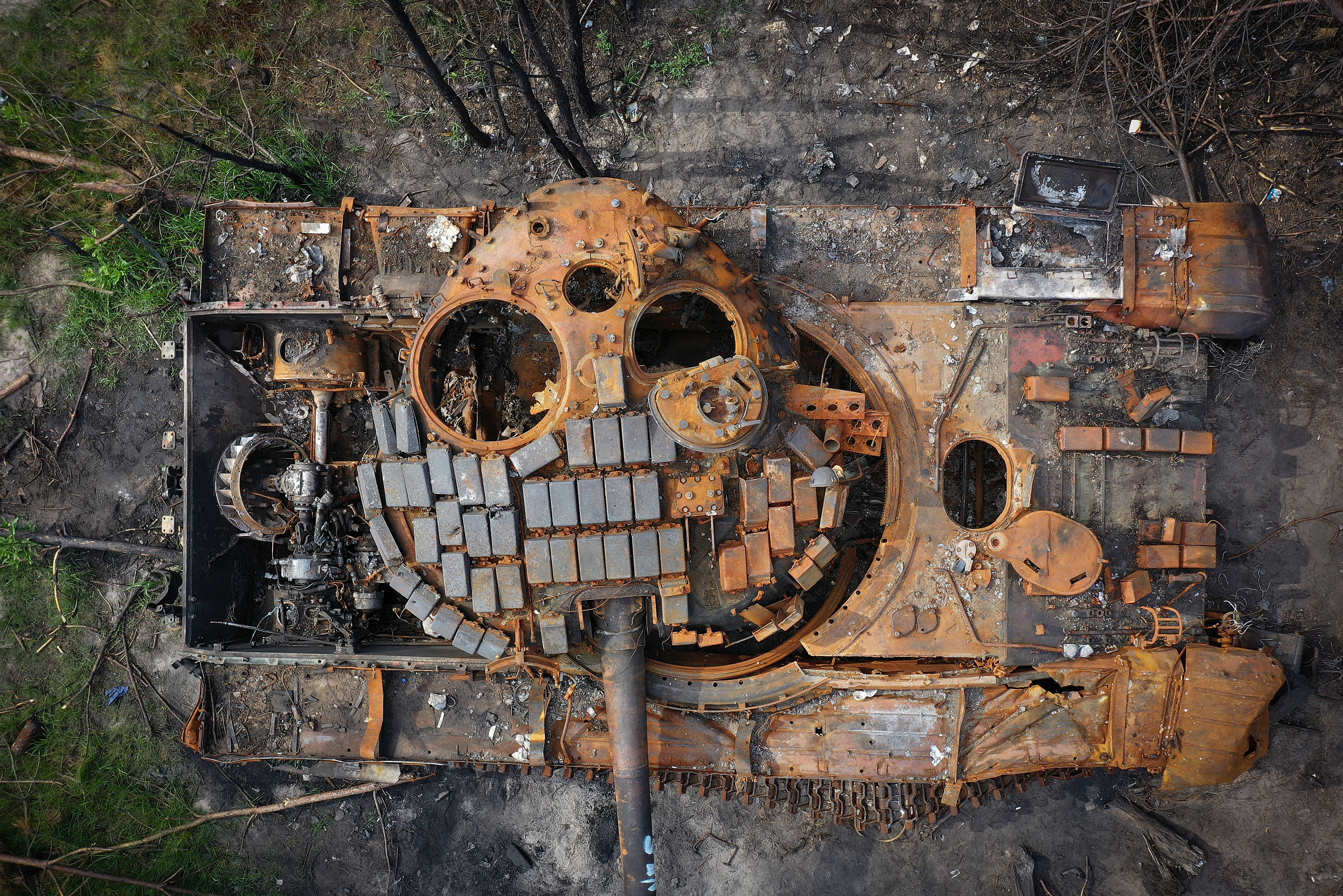 A destroyed Russian tank begins to rust in woodland near Kyiv on June 07, 2022 in Kyiv, Ukraine. A sense of normality has increasingly returned to Kyiv as Russia's assault has focused on the eastern Donbas region. (Photo by Christopher Furlong/Getty Images)
