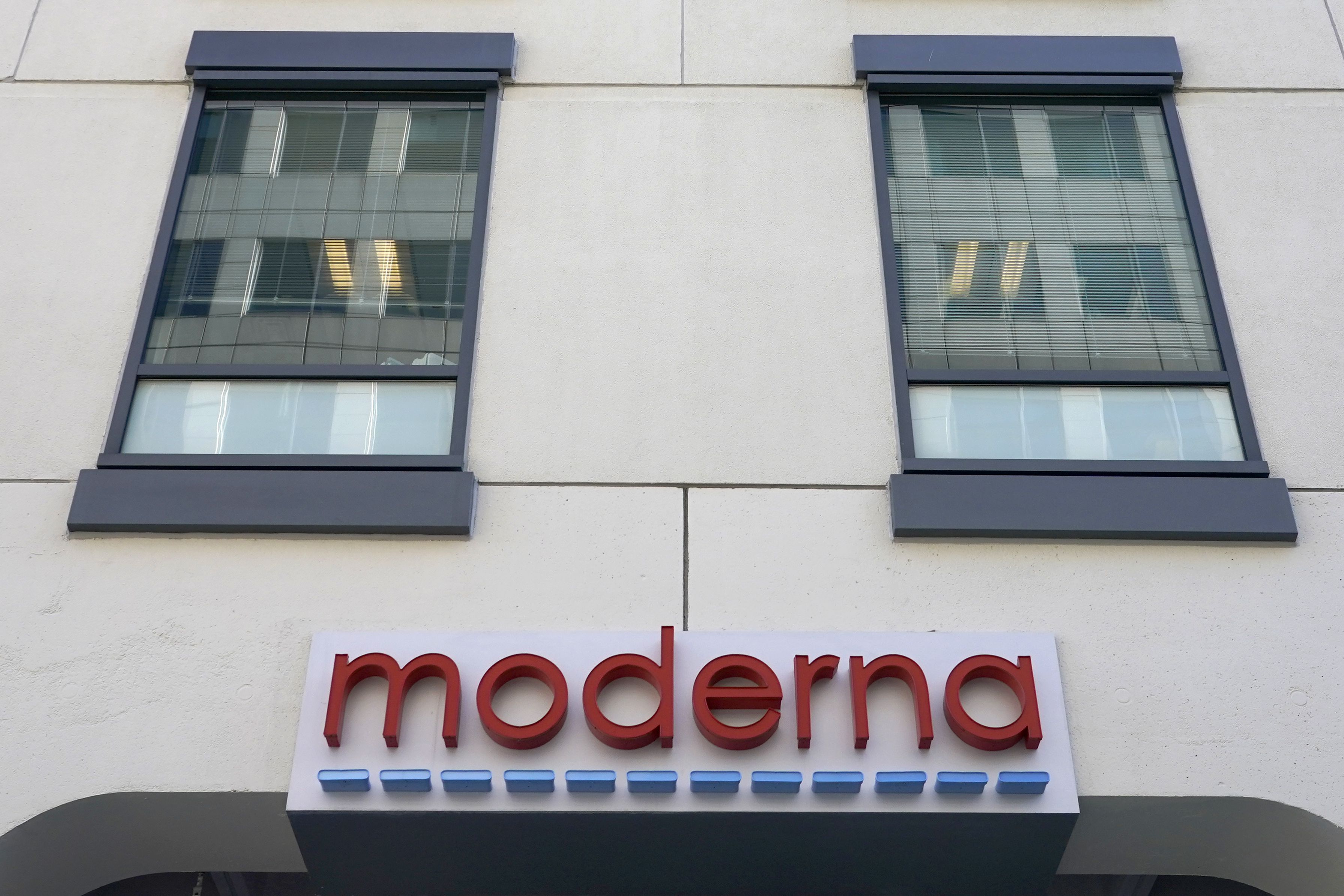 A sign for Moderna, Inc. hangs on its headquarters in Cambridge, Mass.  December 15, 2020 