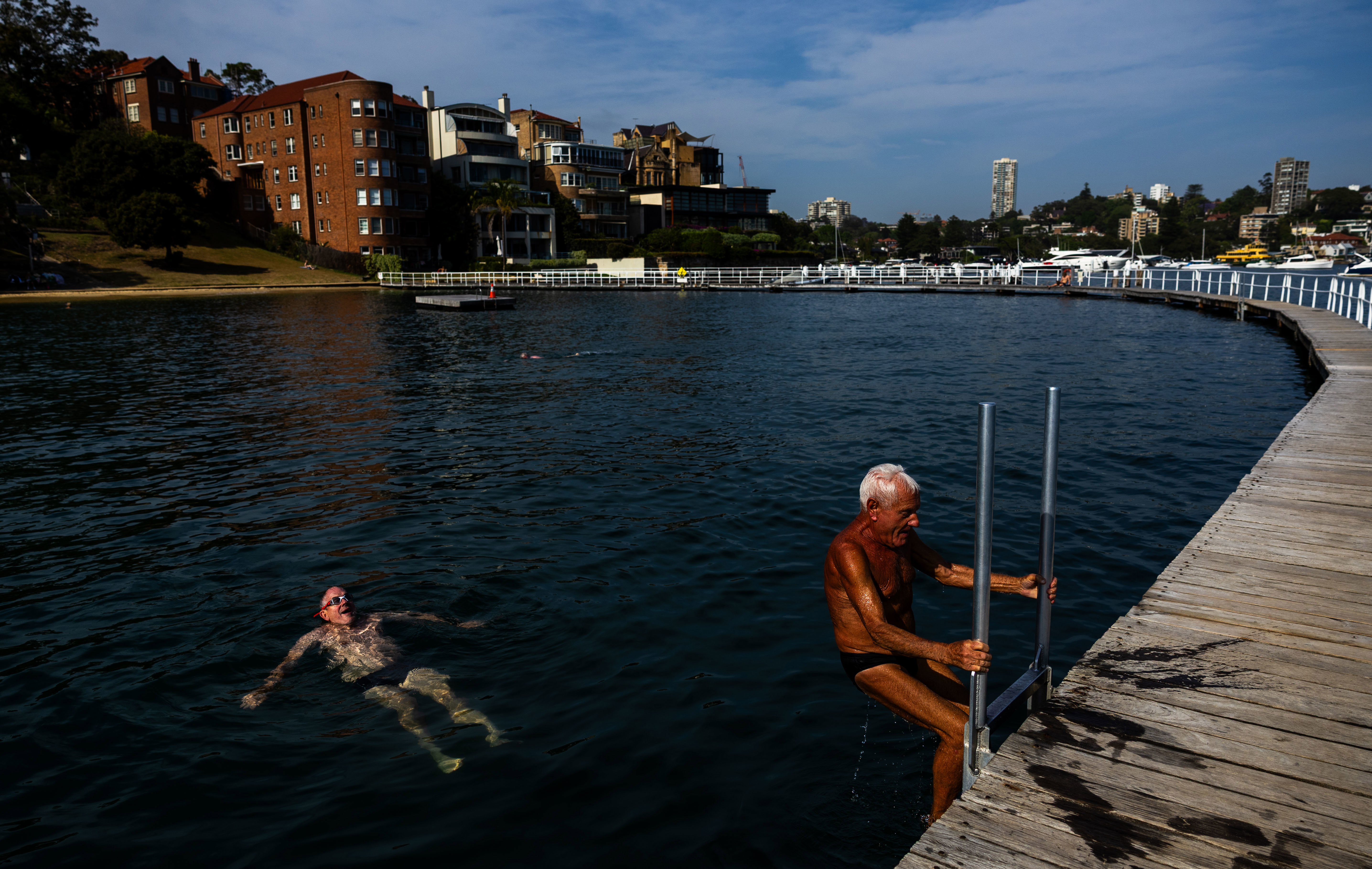 People brave the early morning ahead of the record-breaking heat at Rose Bay's Redleaf Pool in Sydney.