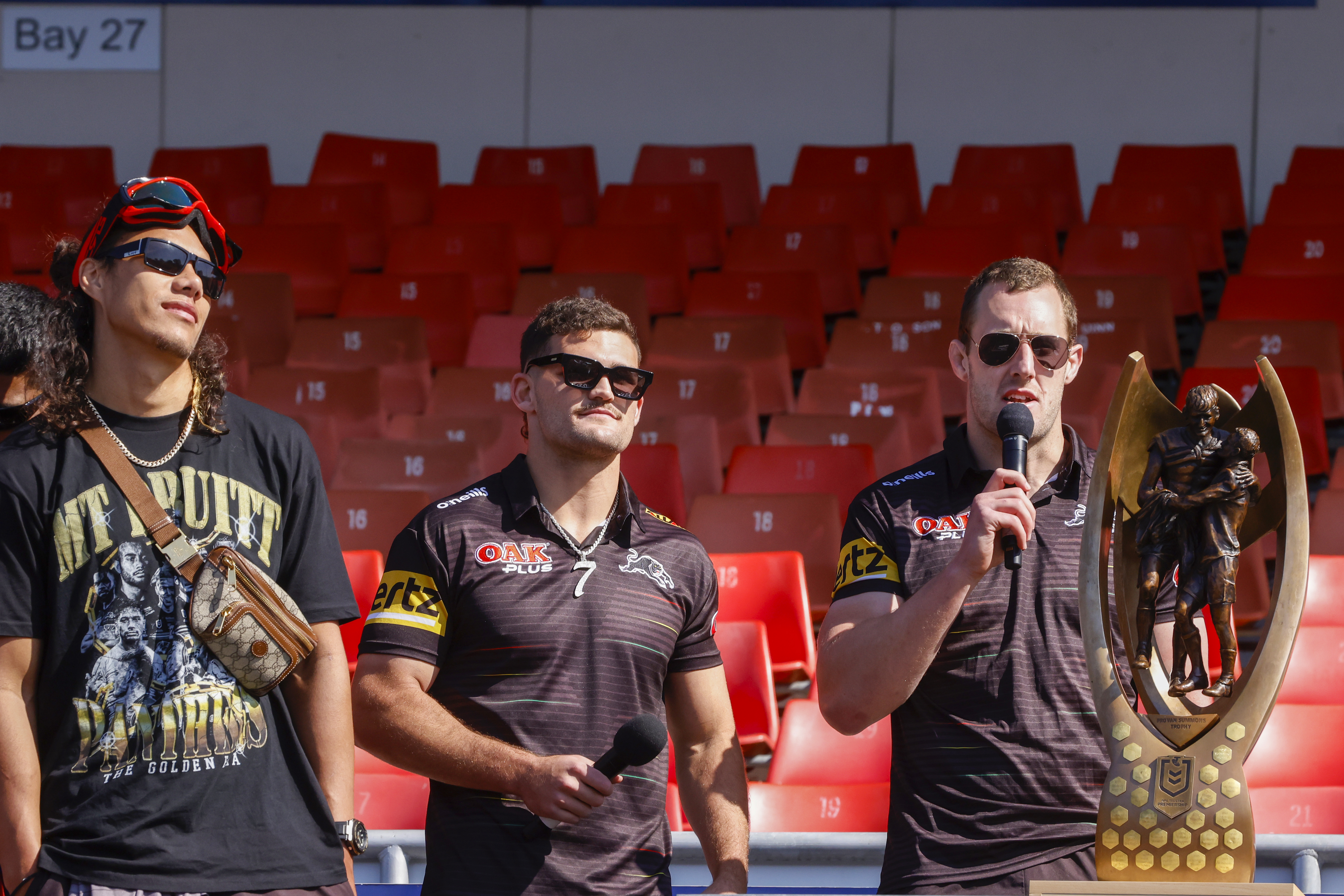 Isaah Yeo speaks as Nathan Cleary (C) and Jarome Luai (L) look on during a fan day at BlueBet Stadium.