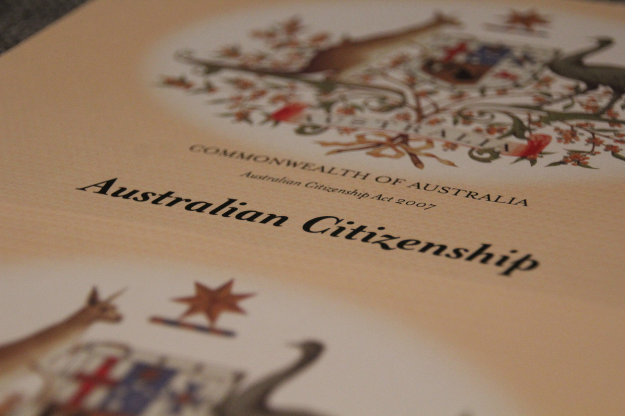 Image of Australian Citizenship Certificate shown with intentional selective focusing. Visible are the Coat of Arms and the details of the Commonwealth of Australia - Citizenship Act 2007.