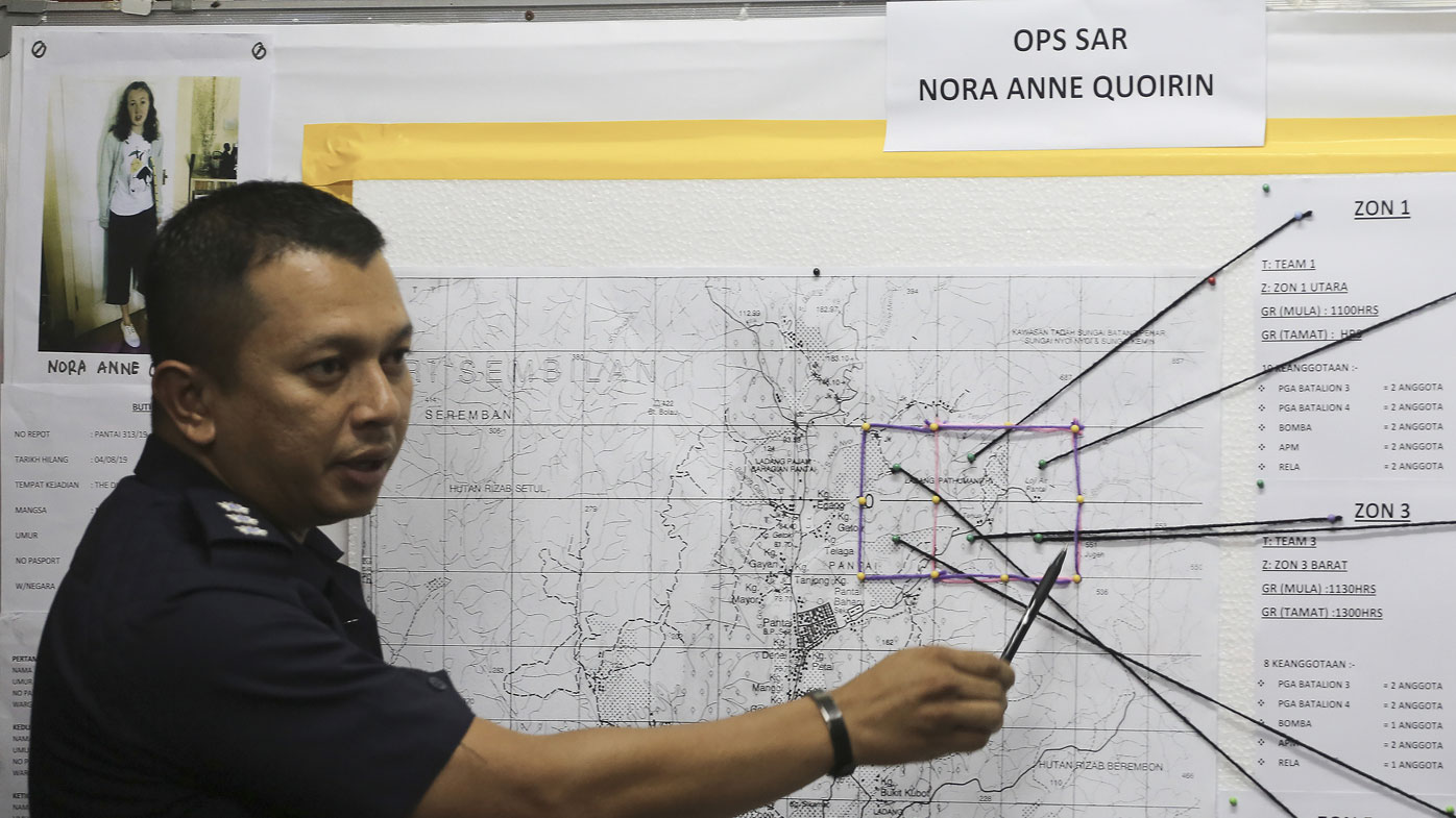 Malaysia's assistant superintendent of police Nasron, who gave only one name, speaks next to a photo of missing British girl Nora Anne Quoirin.