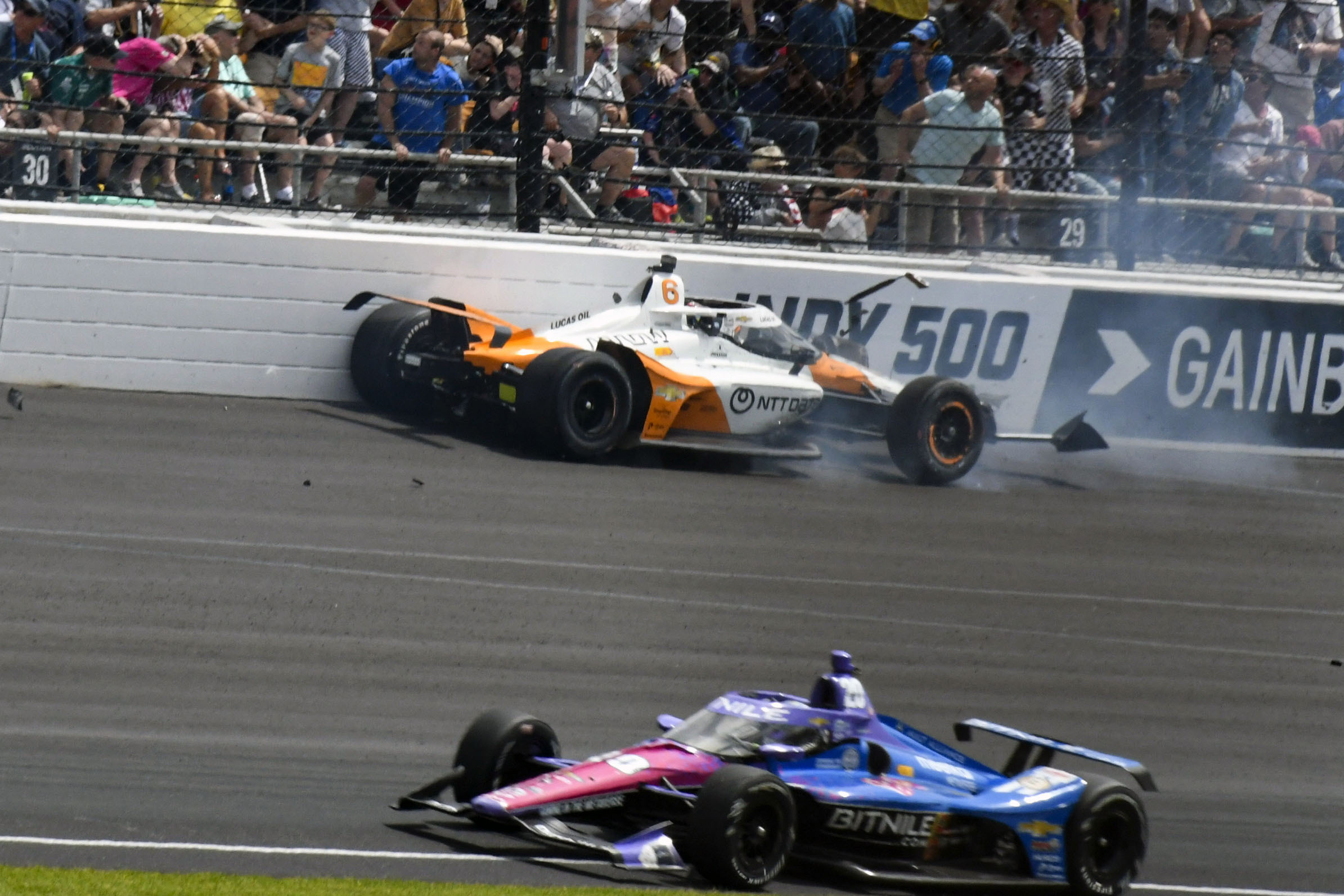 Felix Rosenqvist (top) of Sweden hits the wall in the second turn during the Indianapolis 500.