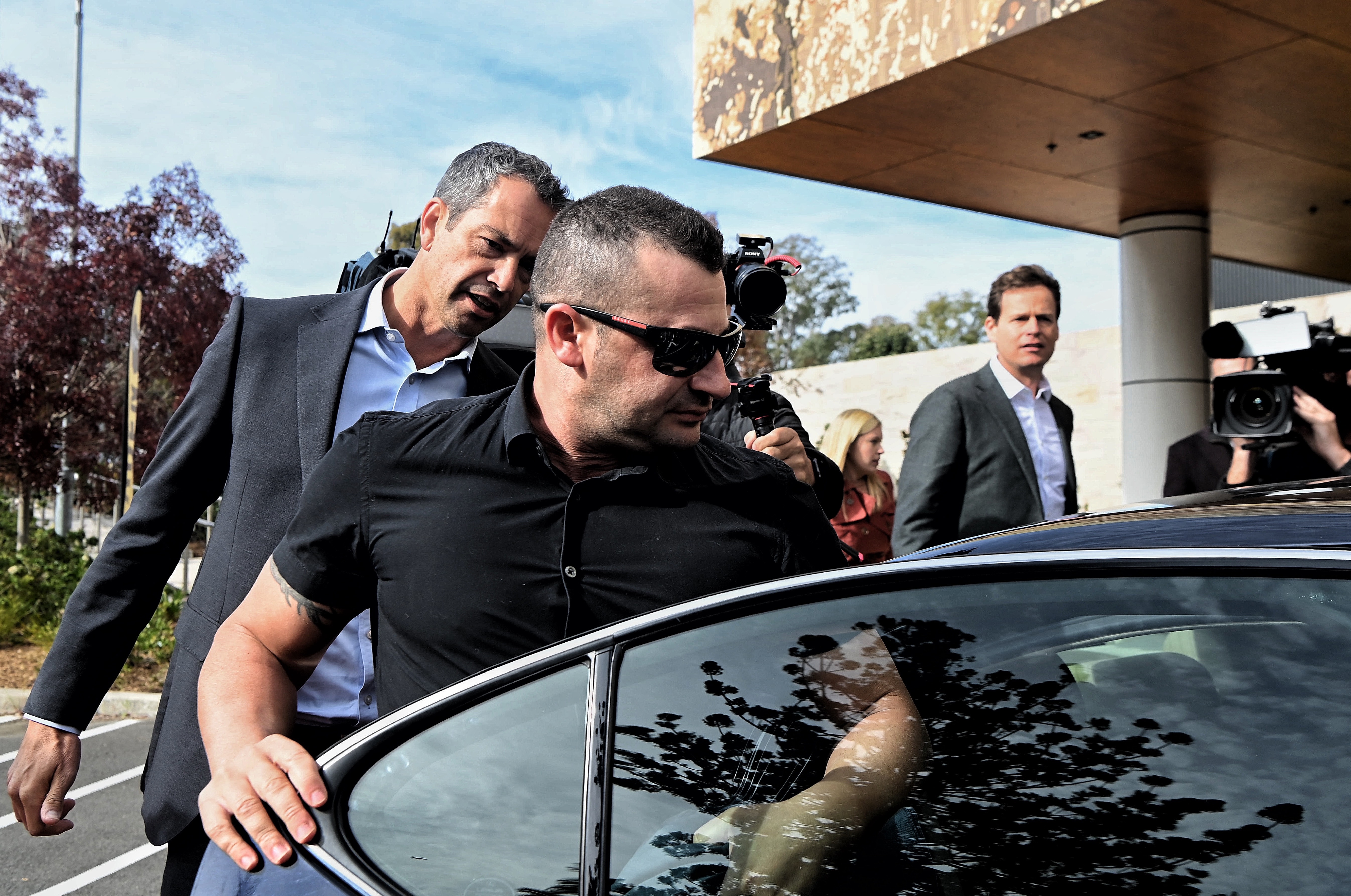 Anthony Koletti (2nd from left) the husband of Melissa Caddick leaves Lidcombe coroners court, NSW.  The coroner concluded that Melissa Caddick is dead however the cause, manner or time could not be determined. Koletti was described as an unreliable witness. May 25, 2023. Photo: Kate Geraghty